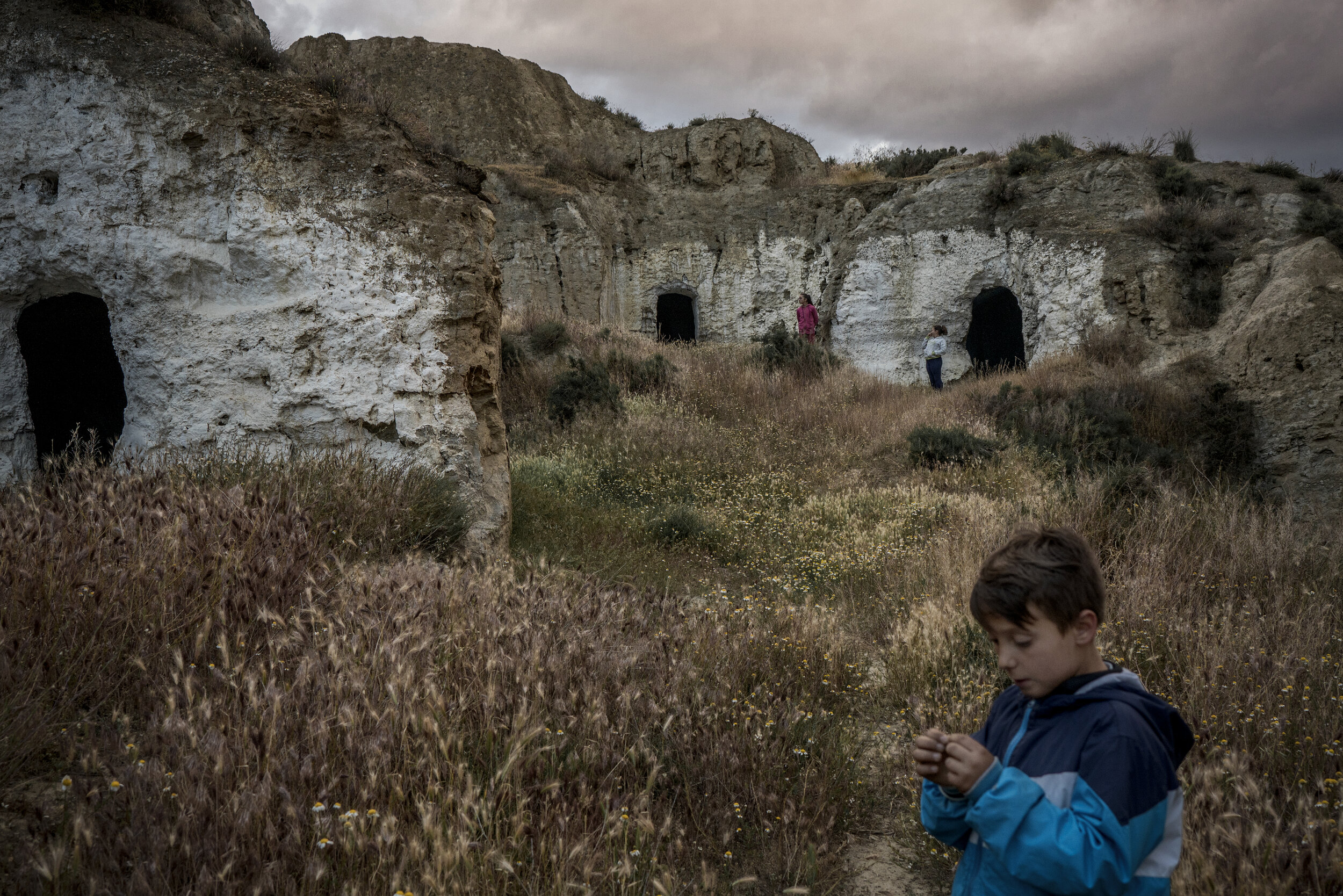  Children play in abandoned caves next to their own cave home.  © Tamara Merino  