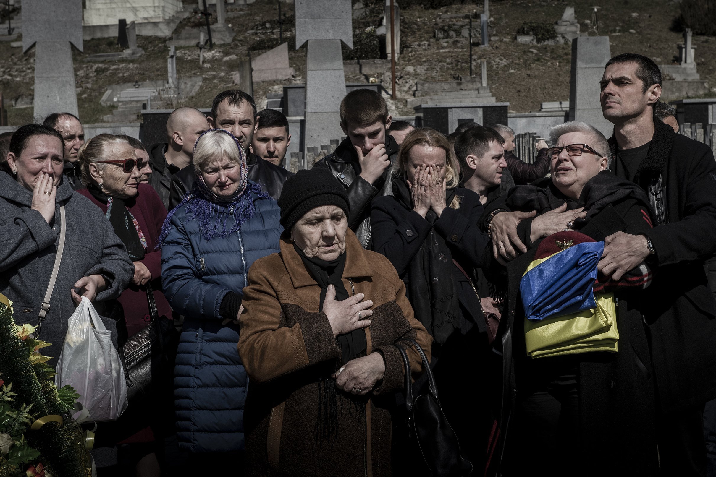  Family and friends grieve at the funeral of soldier Fedorchyk Ihor Volodymyrovych at the Lychhakiv cemetery in Lviv, Ukraine, March 24, 2022. Volodymyrovych was killed in combat in Nova Kakhovka, near Kherson, on the second day of Russia’s invasion 