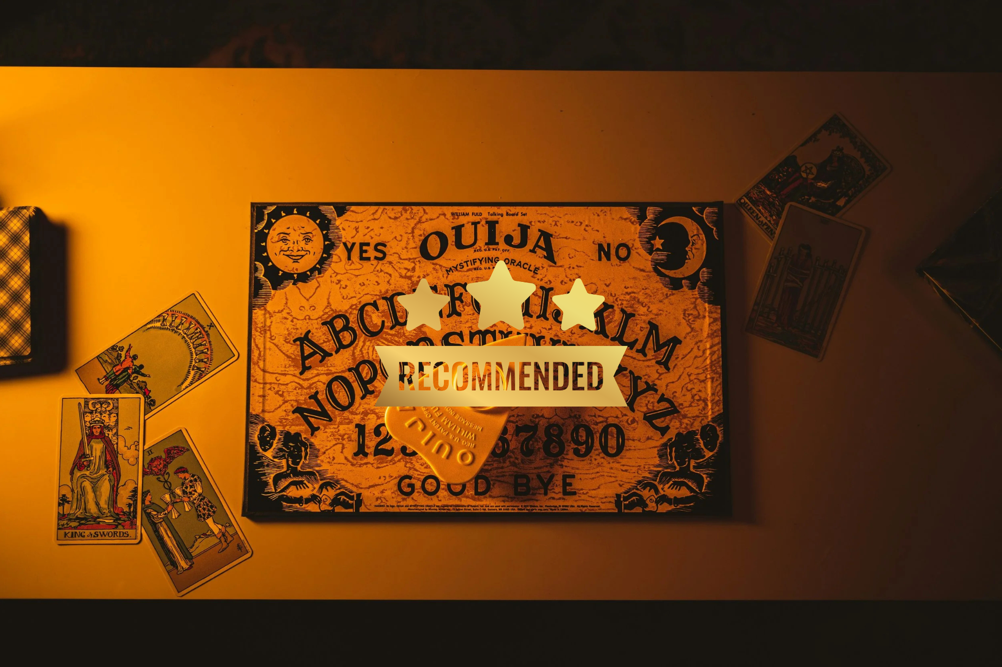 A Ouija board on a table with tarot cards around it, featuring the words 'YES', 'NO', and 'RECOMMENDED'.