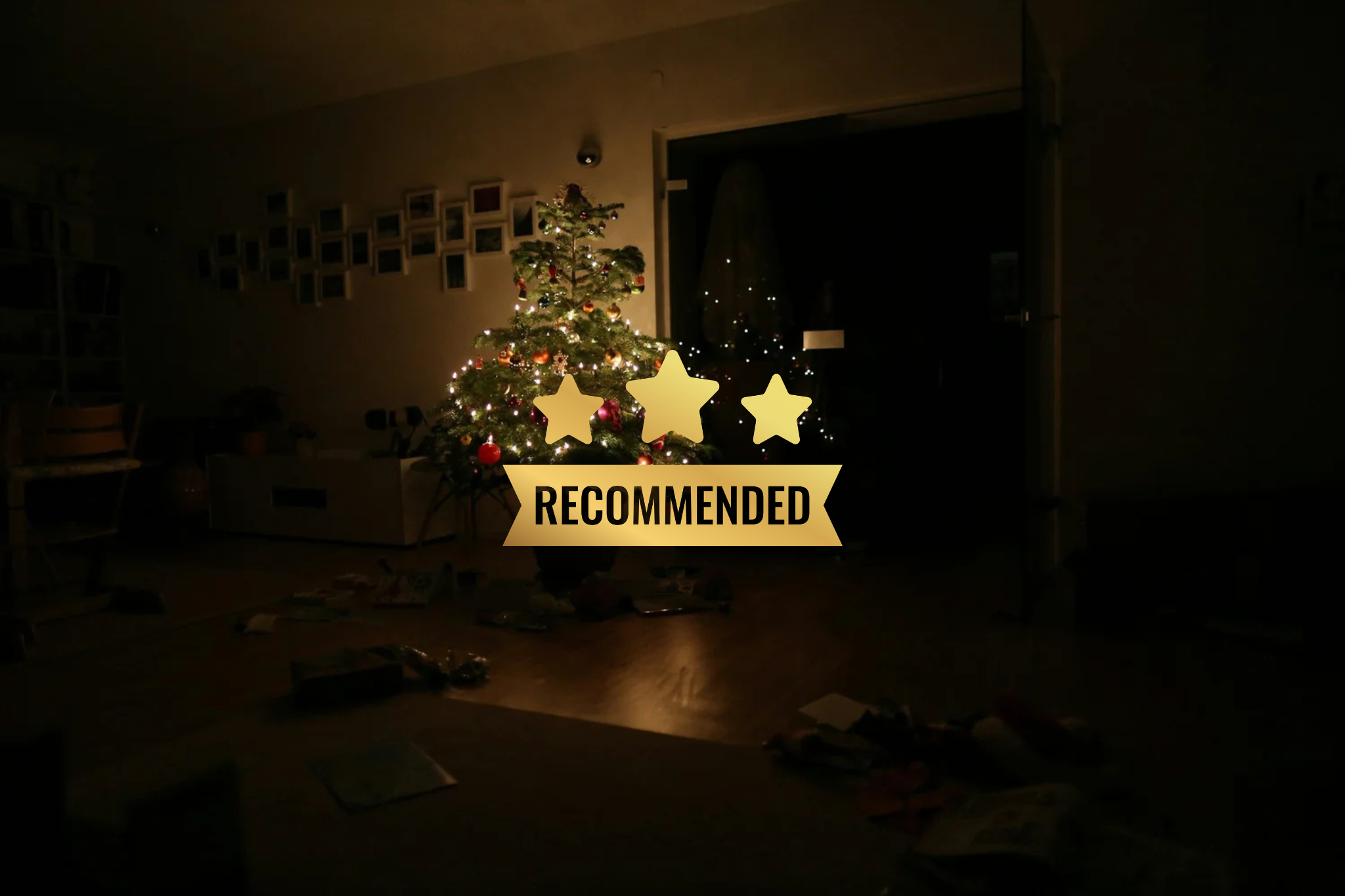 Christmas tree decorated with lights and ornaments in a dimly lit room, with a "RECOMMENDED" label featuring stars overlayed.