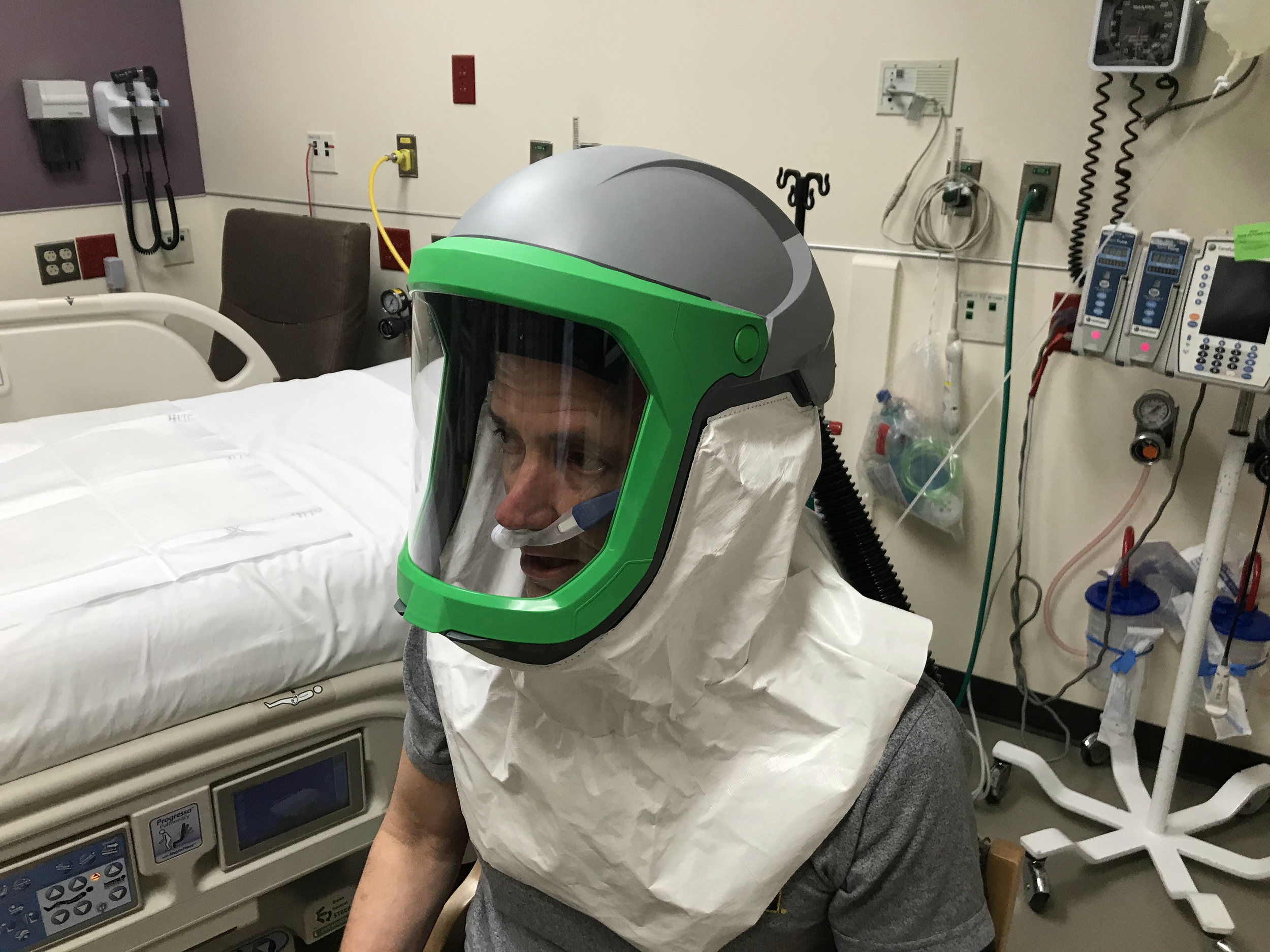  Dr. Kevin Ward tests the negative pressure helmet system. Preliminary data shows airflows through the hood approach 320 liters/minute, which is more than 20 times greater than the air exchanges produced by a negative pressure room. 