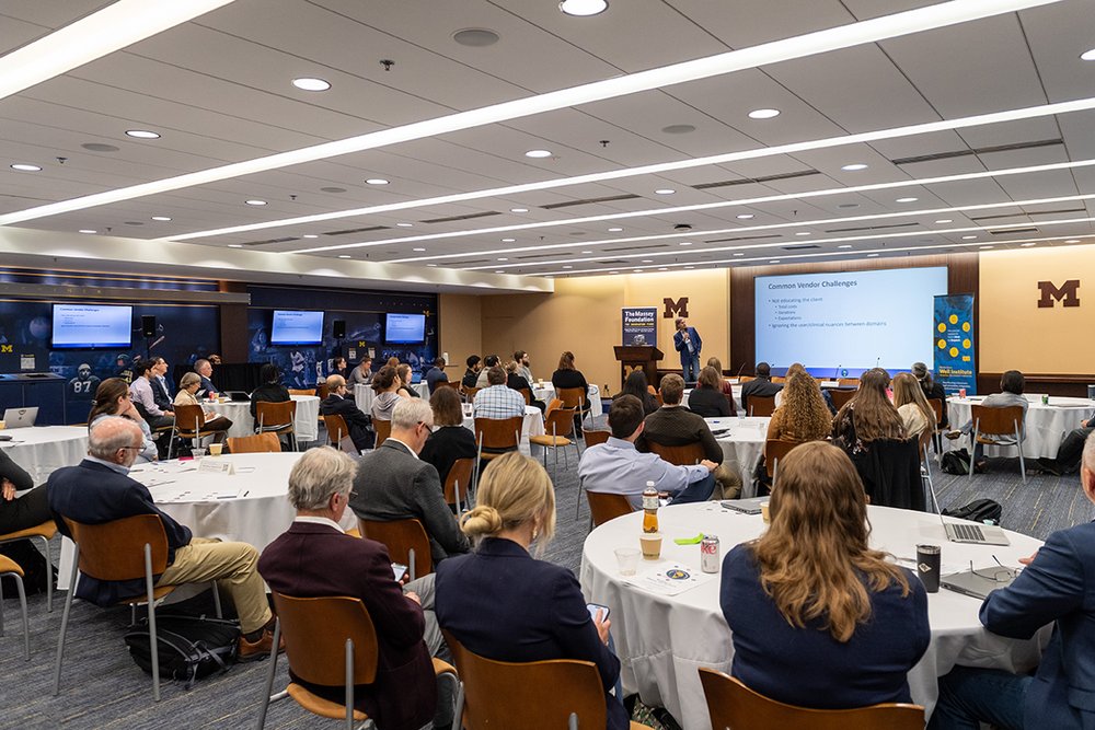  Conference attendees listen in as Gene Parunak, Director of in2being, presents on commercializing medical innovations. 