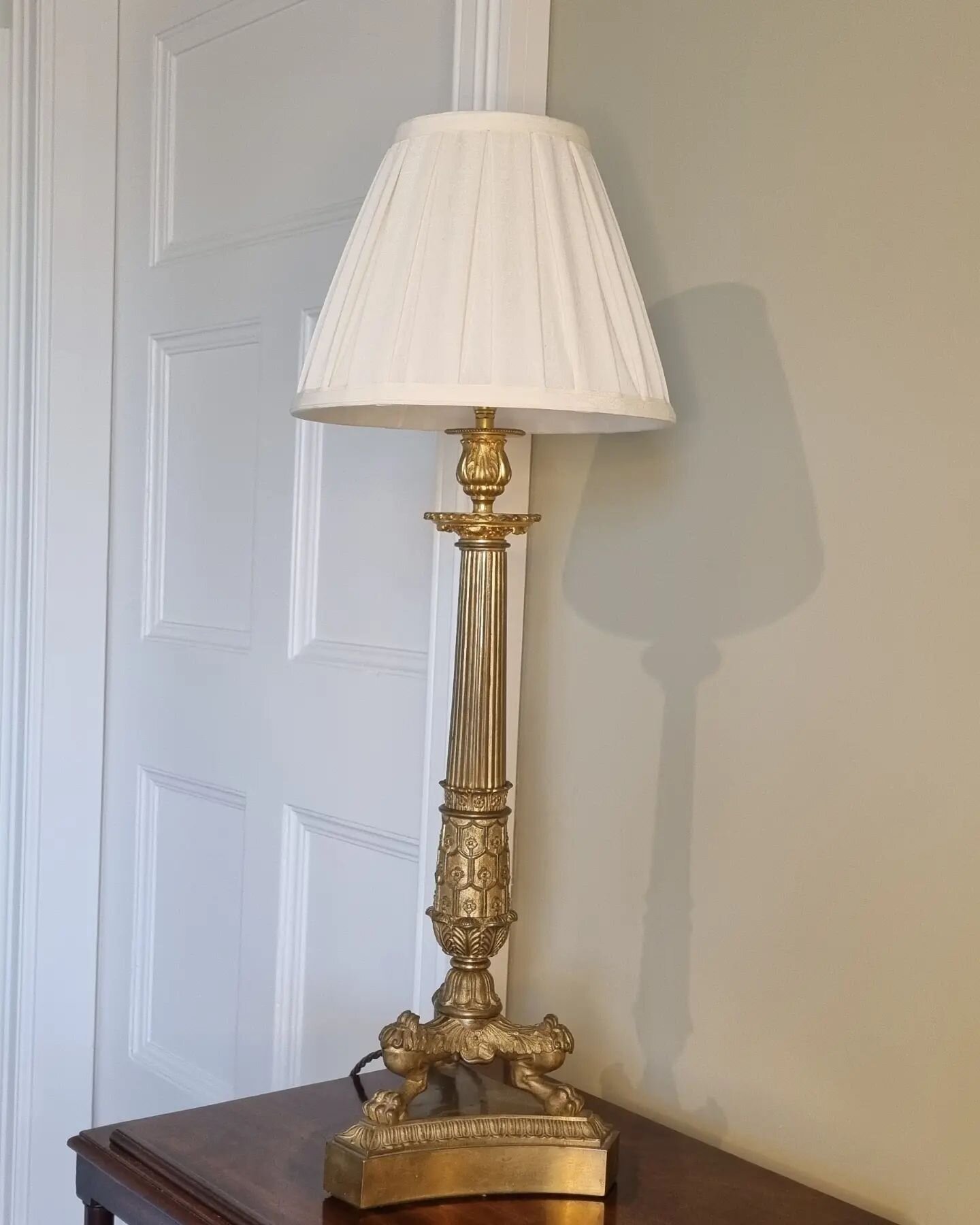 A large Regency period gilt-bronze candle stick converted to a lamp with tapered fluted column the lower section with gilt foliate mounted paw feet, supported on a tripartite platform.

Note. Top mount later.

Height 58cm 

English Circa, 1815

&poun