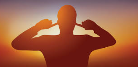 Person sitting quietly and emotionally withdrawn during conflict.