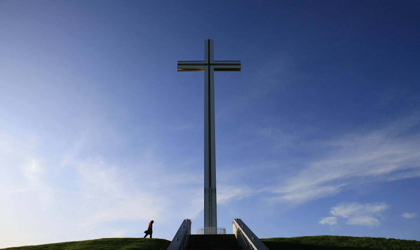  A lone member of the public walks up to a memorial in Phoenix Park where Pope John Paul II gave mass to over one million people on 29 September 1979. A 700 page report from the Commission of Investigation into sexual abuse allegations is released to