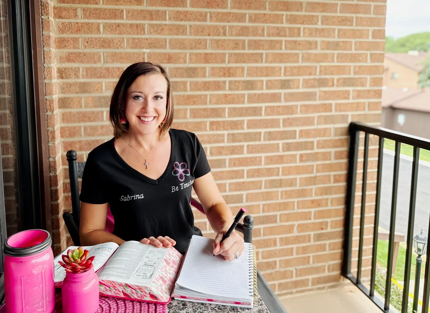 speaker Sabrina Schottenhamel smiling while writing in her notebook