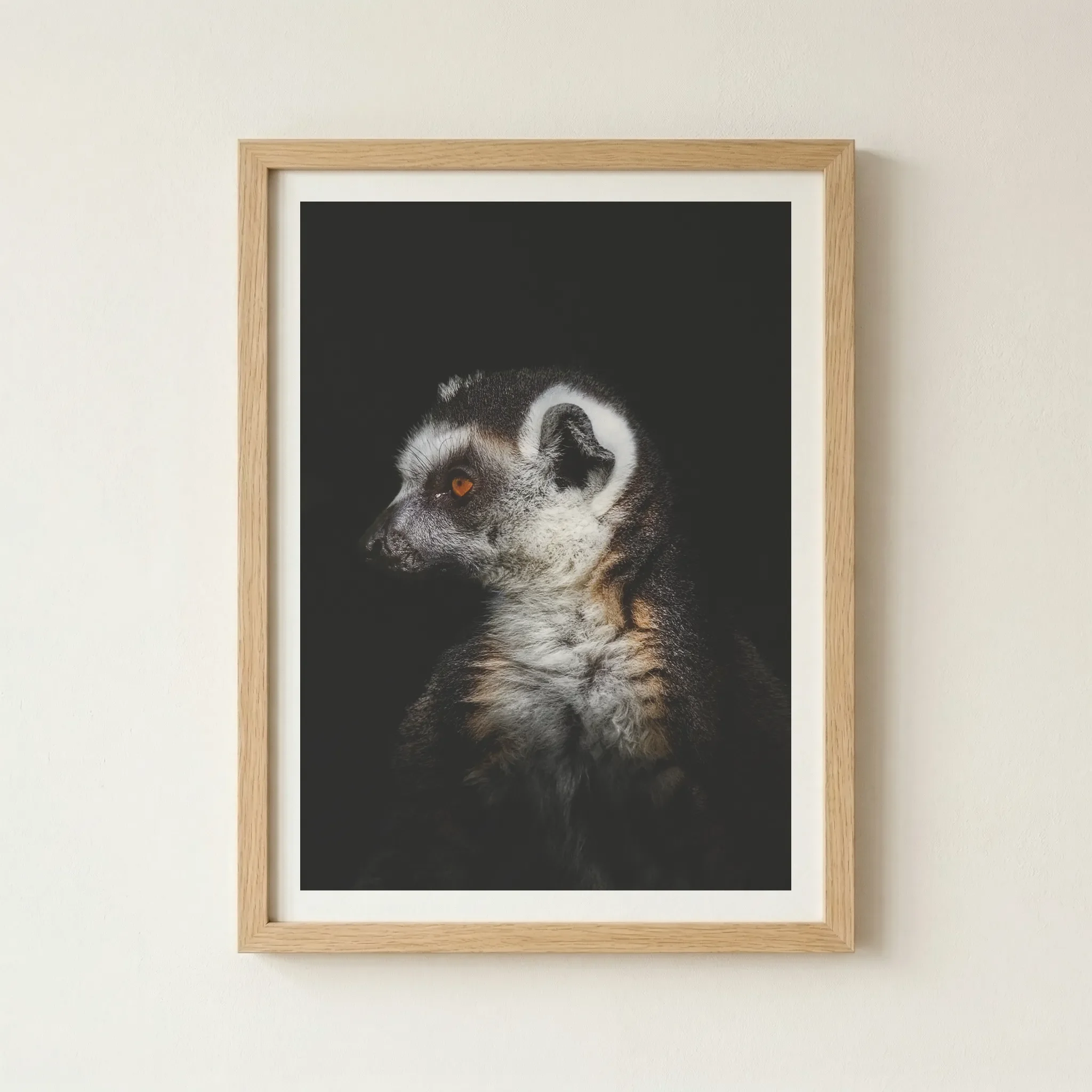 'Lemur' fine art print in a natural wood frame, adding an earthy, organic warmth to this dramatic study of Madagascar's most iconic primate.