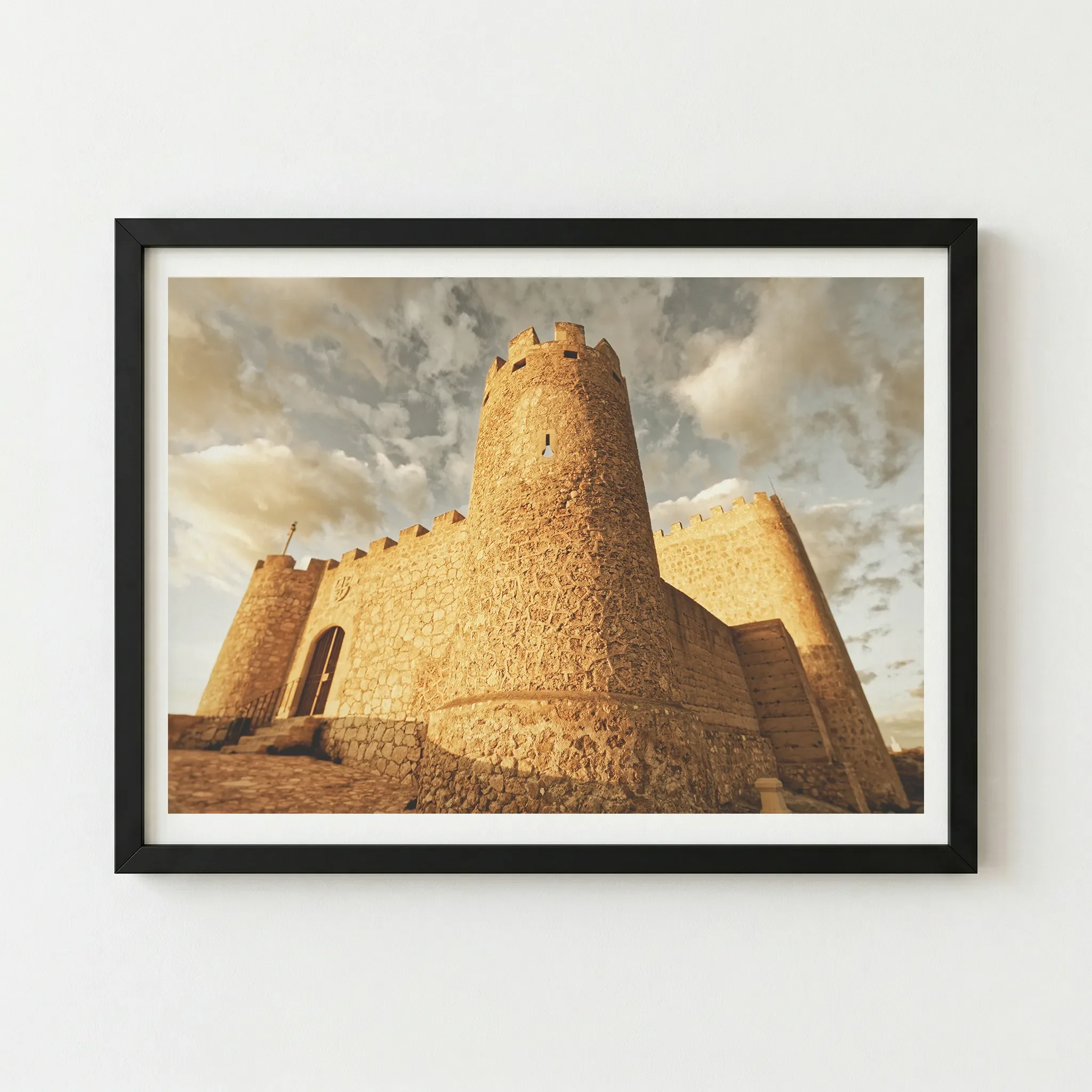 The Castillo de Jumilla artwork in a black wooden frame, providing a sharp, contemporary border that enhances the high-contrast shadows of the fortress.