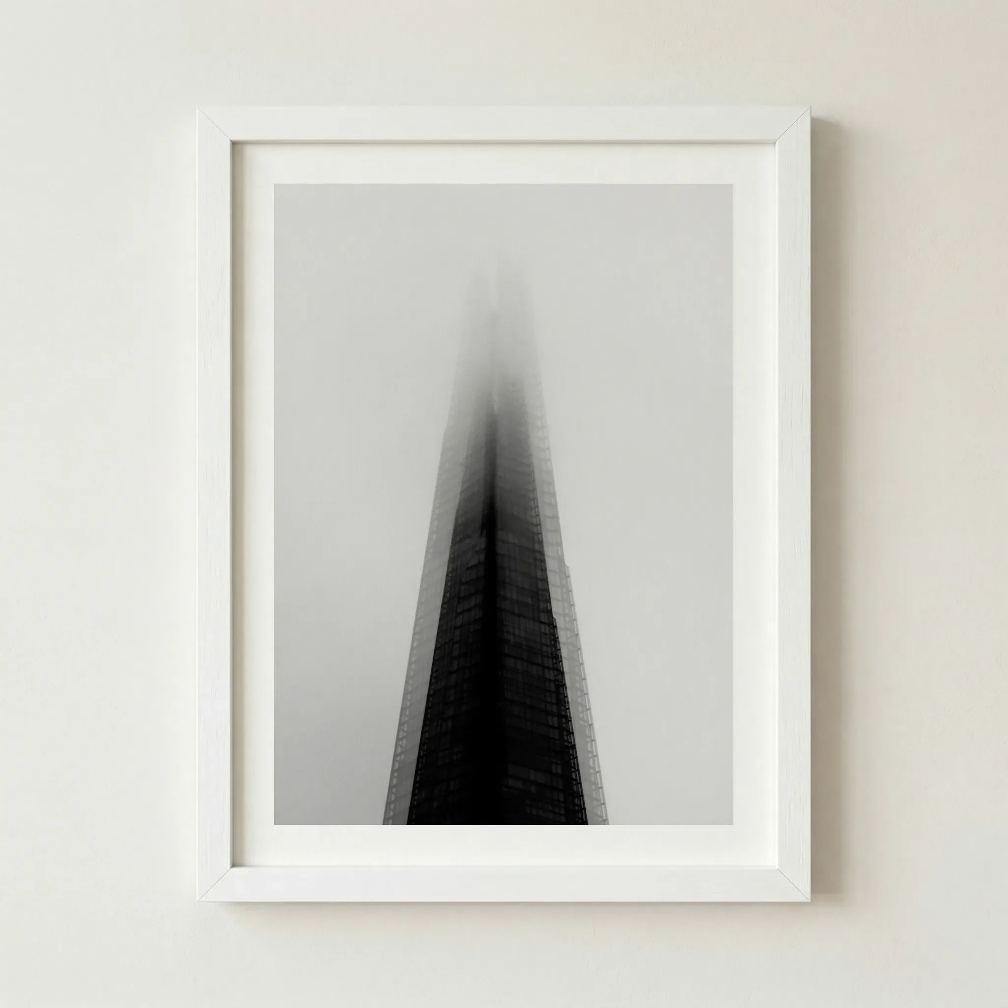 The Shard fine art print in a white frame, creating a seamless transition between the foggy sky and the frame for a clean, minimalist look.