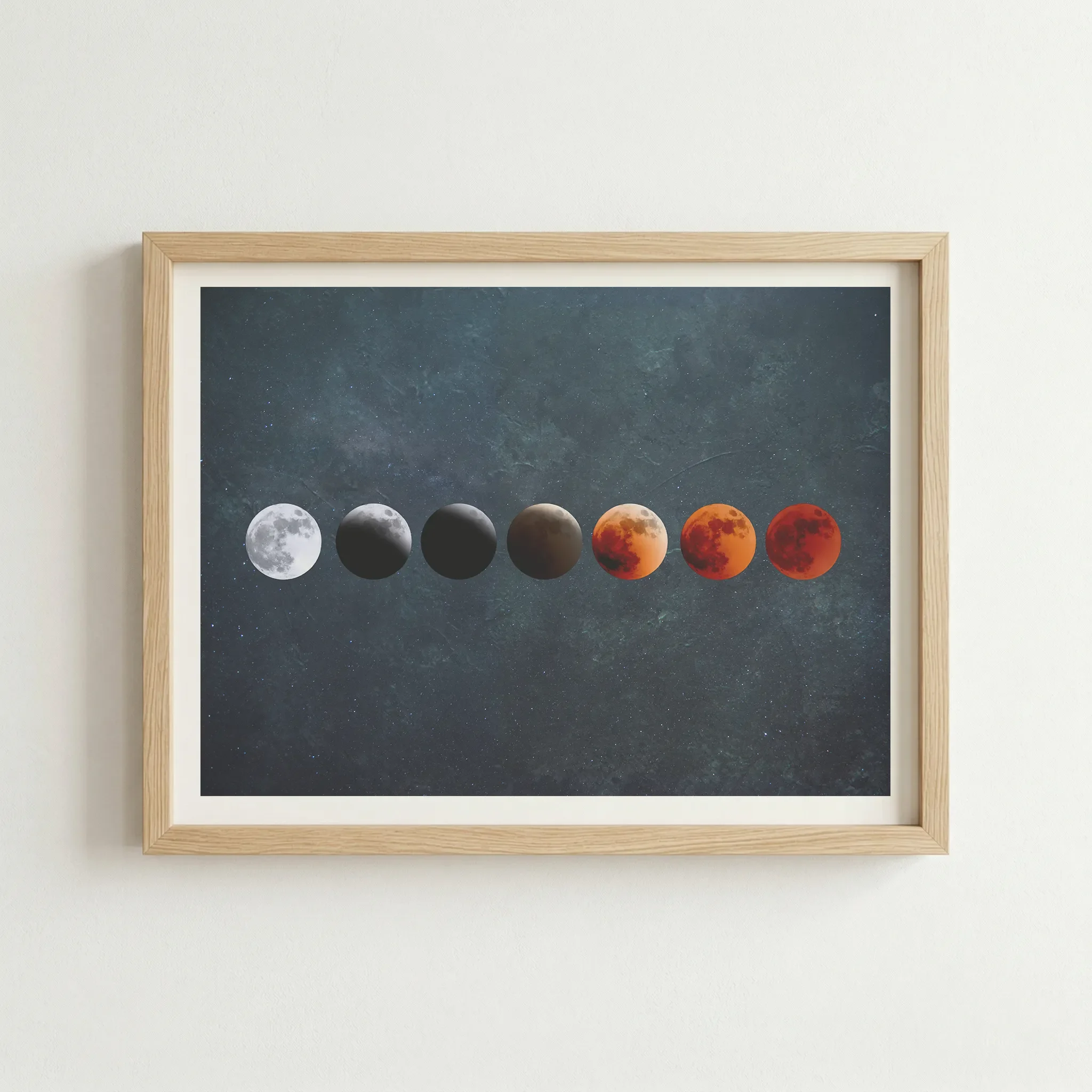 Celestial Blood Moon print in a natural wood frame, grounding the cosmic imagery with a warm, organic finish.