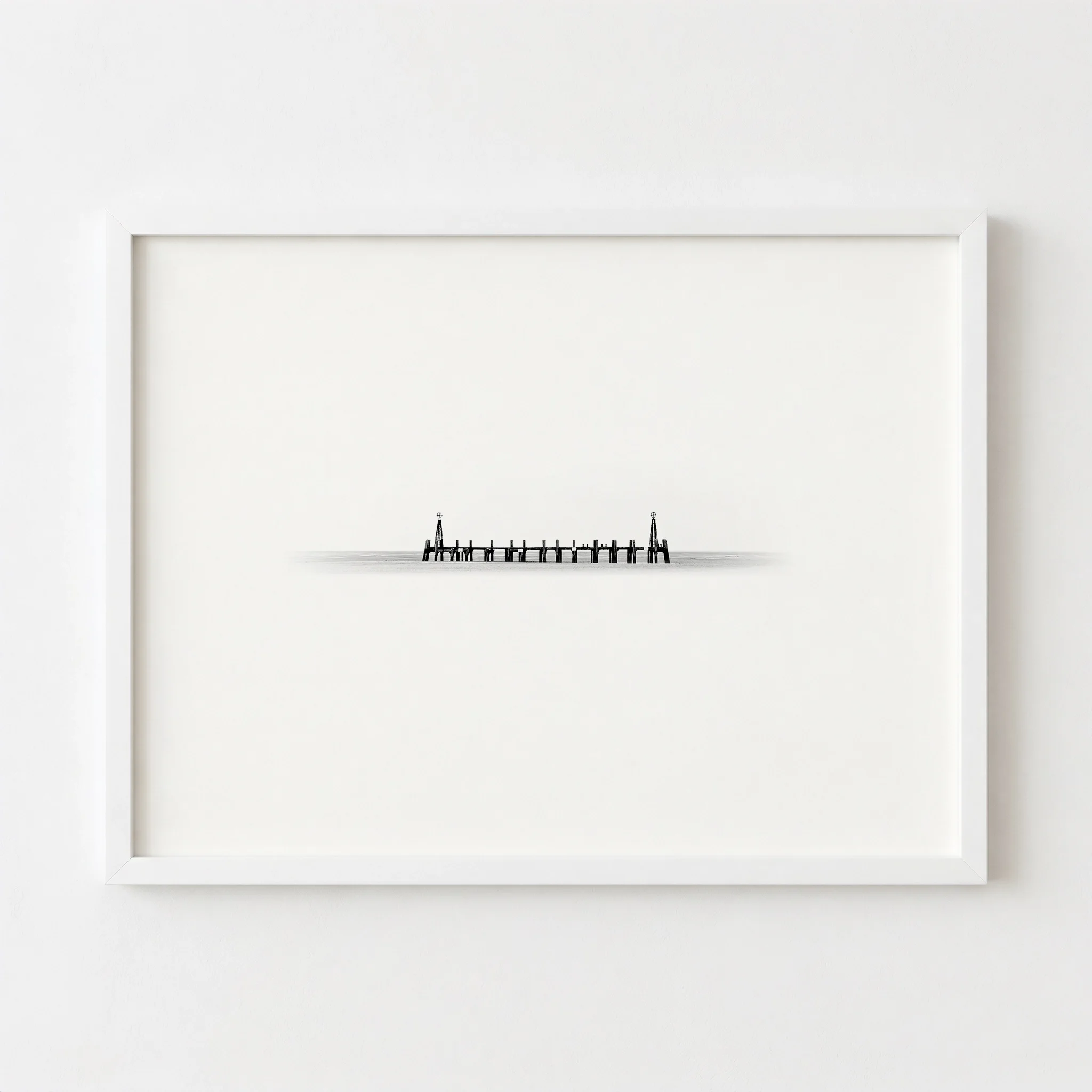 The pier art in a white frame, creating a seamless "infinity" look against the wall.