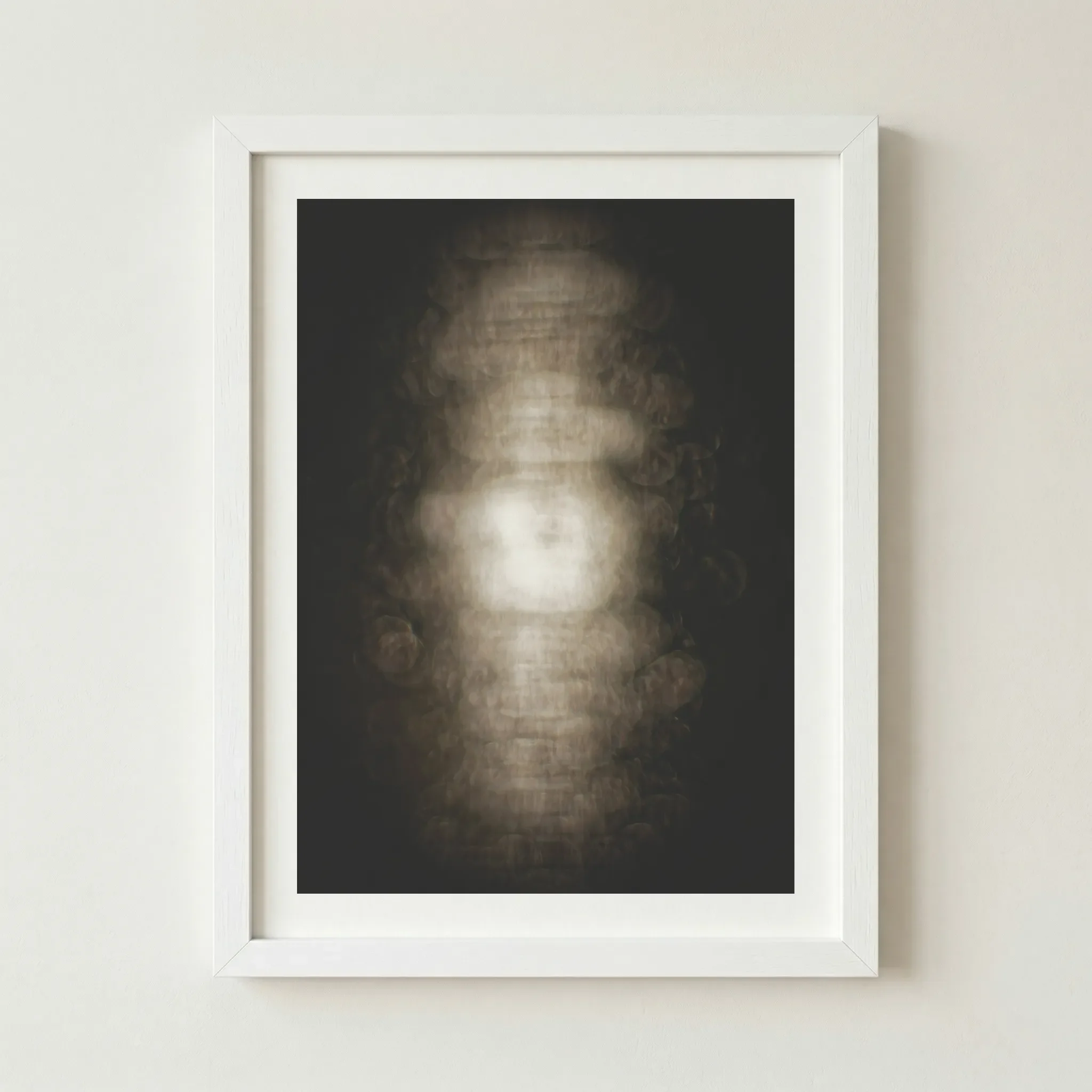 Modern abstract cocoon print in a white frame, creating a sharp contrast that makes the central orb of light appear more luminous.