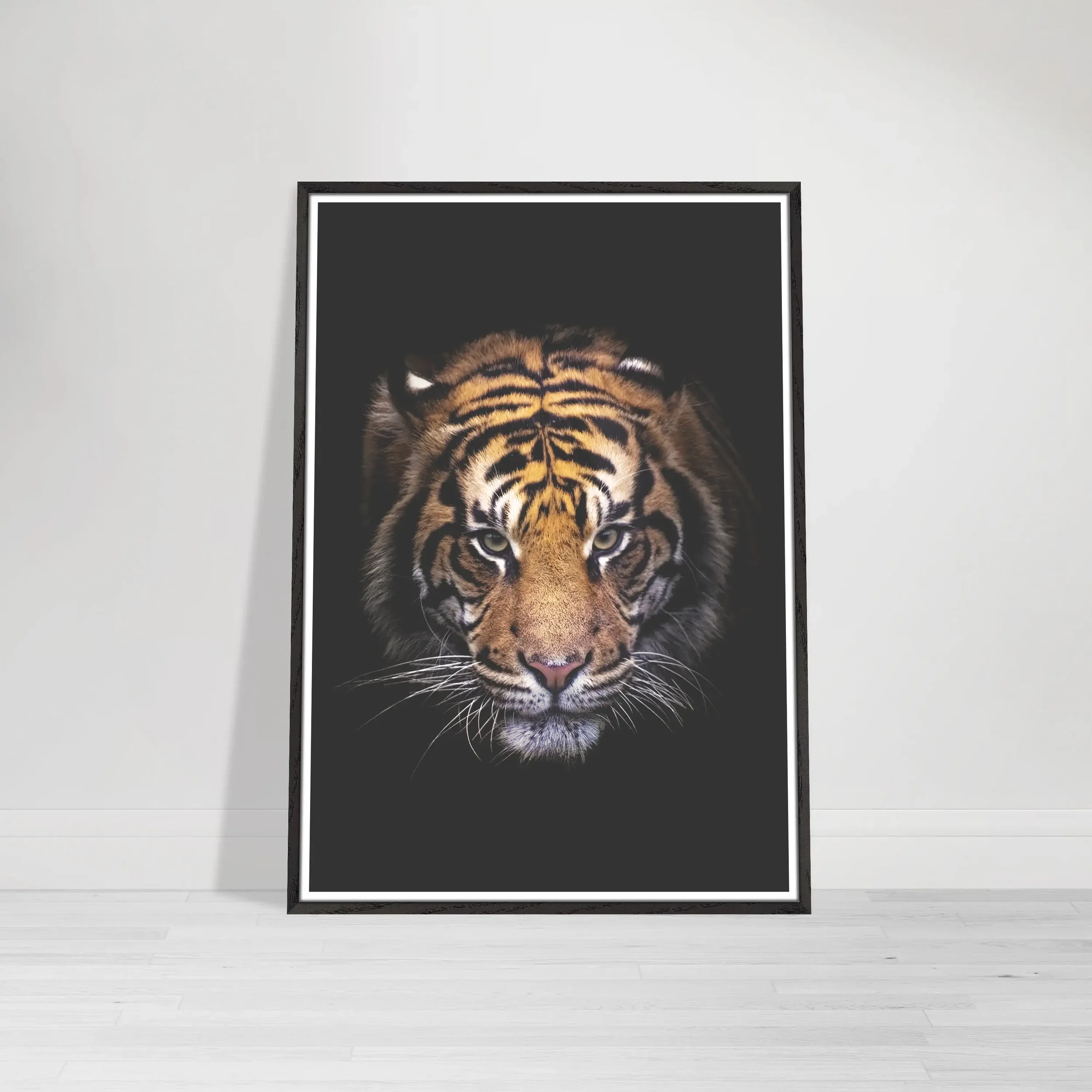 The 'Portrait of a Tiger' print in a black wooden frame, creating a seamless, dramatic extension of the dark shadows for an immersive, modern gallery look.