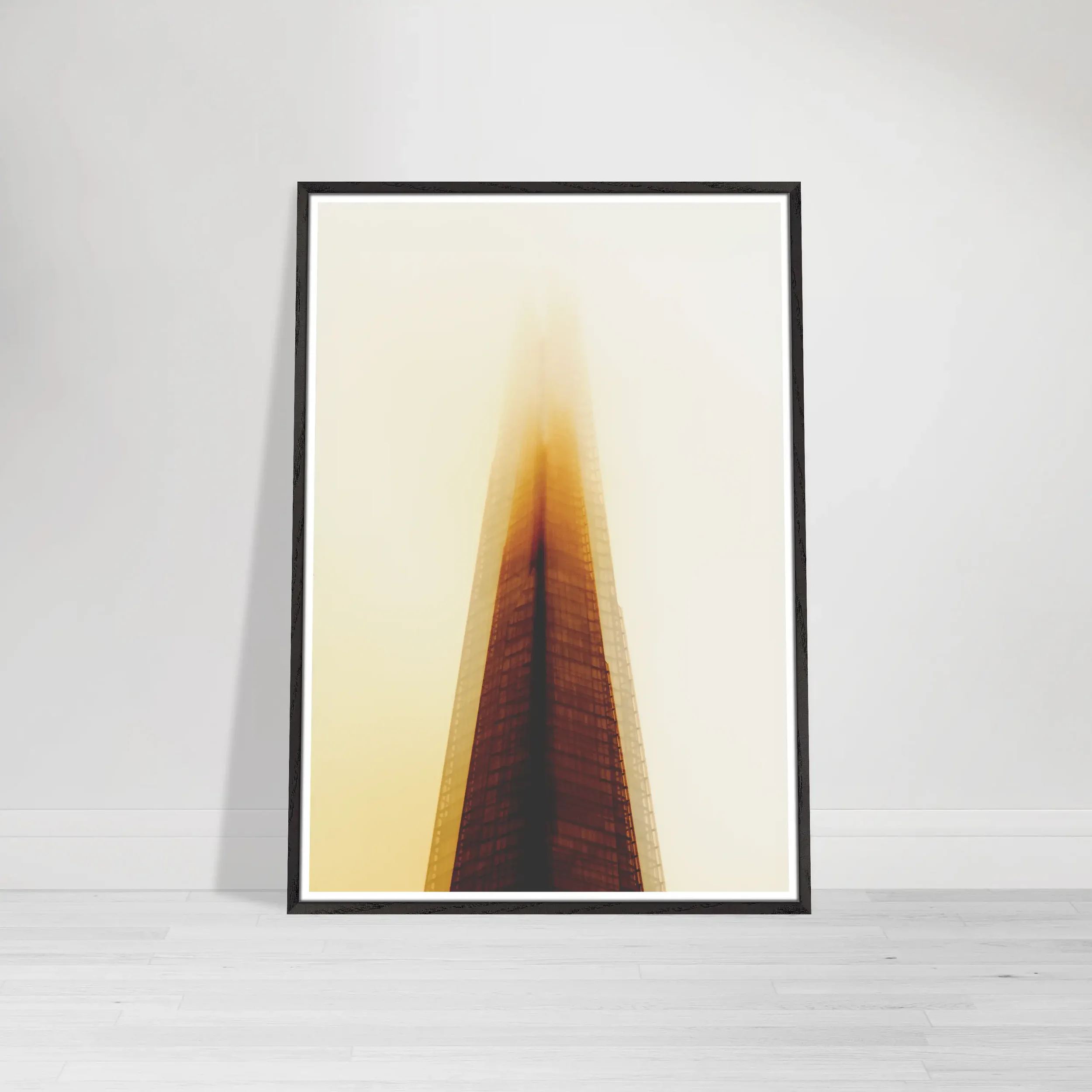 'The Tower of Light' print in a black wooden frame, providing a sharp, modern contrast that makes the golden architectural glow feel exceptionally vibrant.