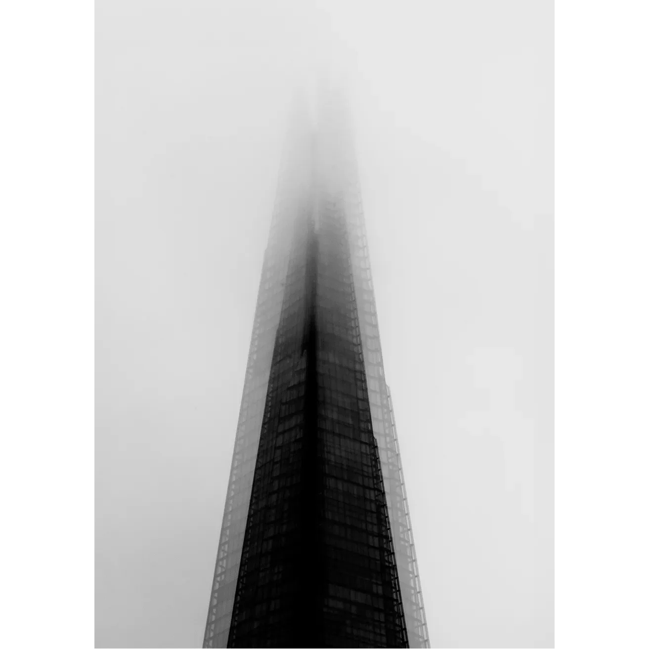 Minimalist black and white fine art print of London's Shard piercing through a thick, heavy fog by GG Digital Creations.