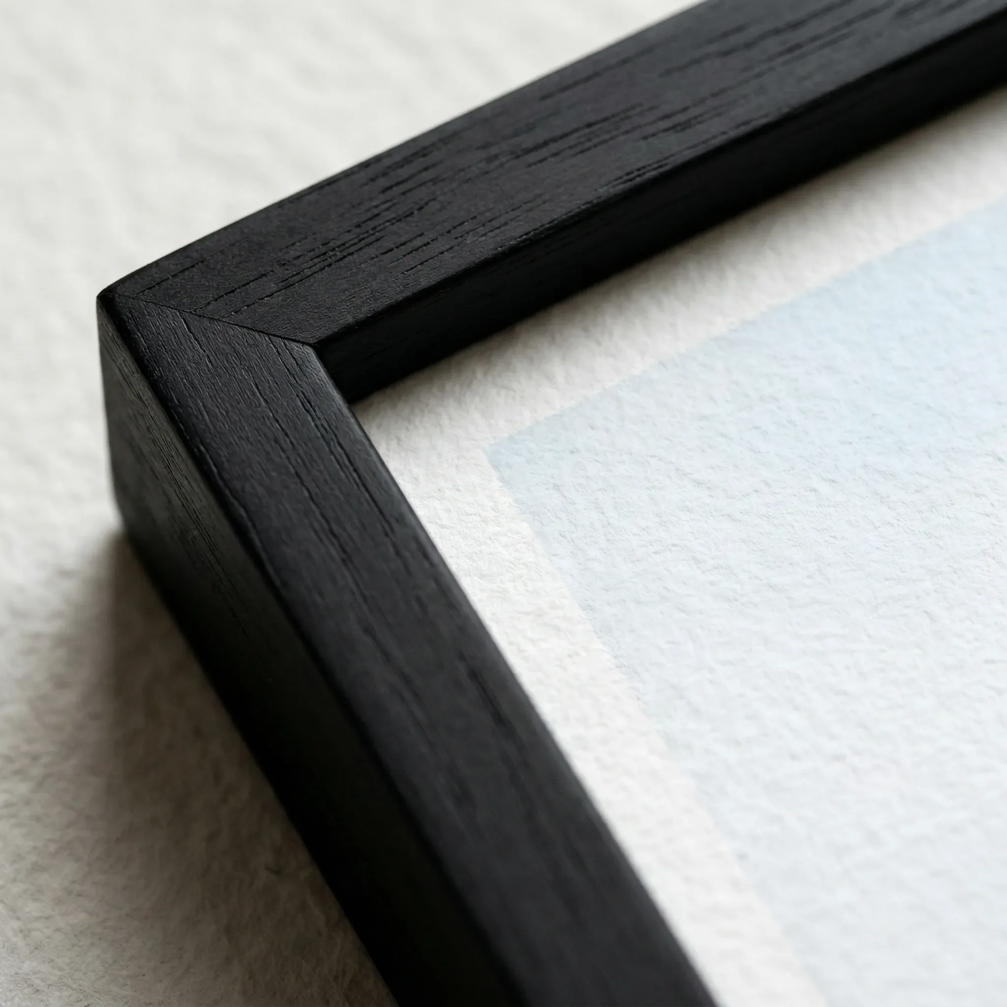 Distorted Reality Black Frame Micro Close up The 'Distorted Reality' abstract print in a black wooden frame, which grounds the chaotic energy and intensifies the deep, shadowy mid-tones.