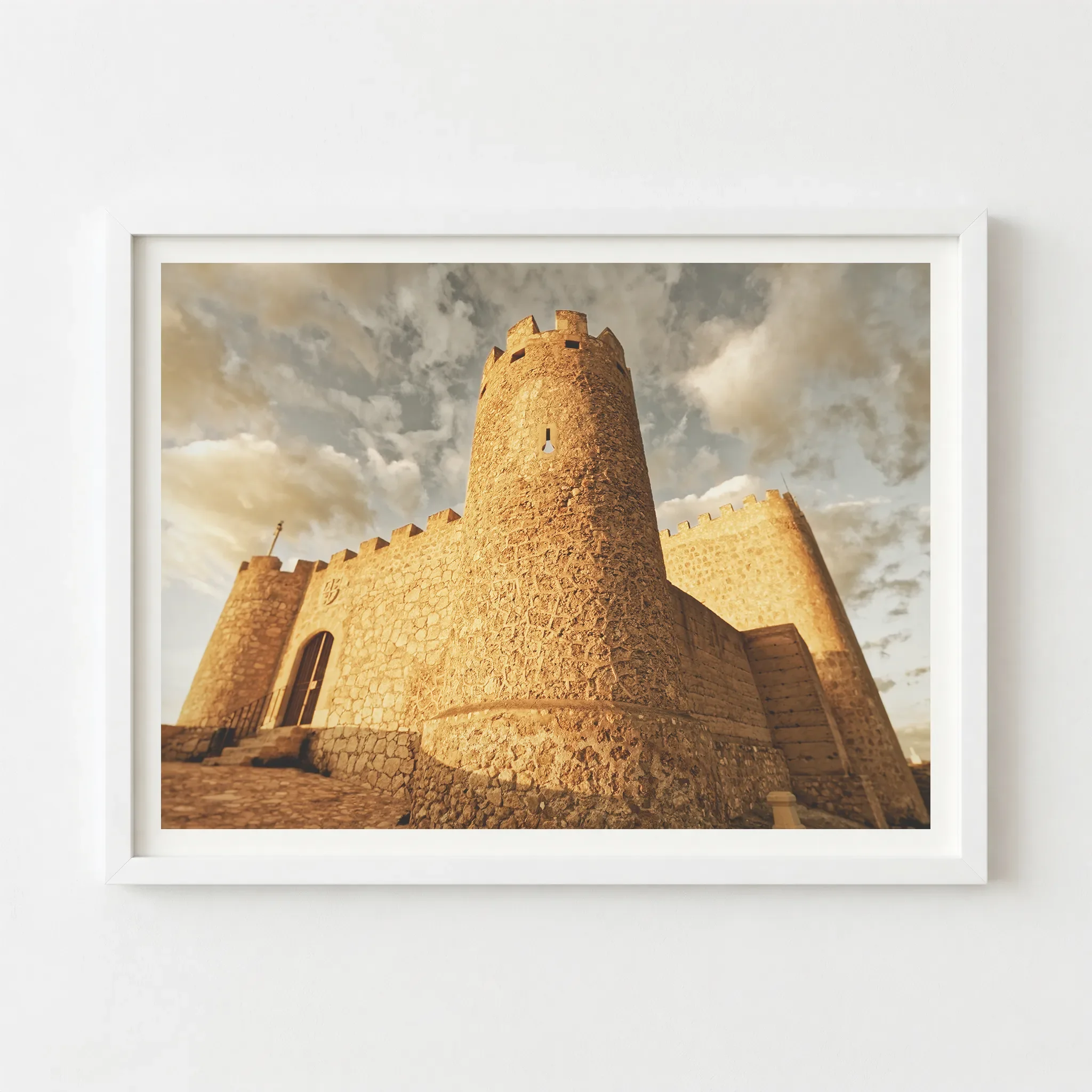 The Spanish castle print in a modern white frame, creating a clean, airy aesthetic that emphasises the soft, golden clouds.