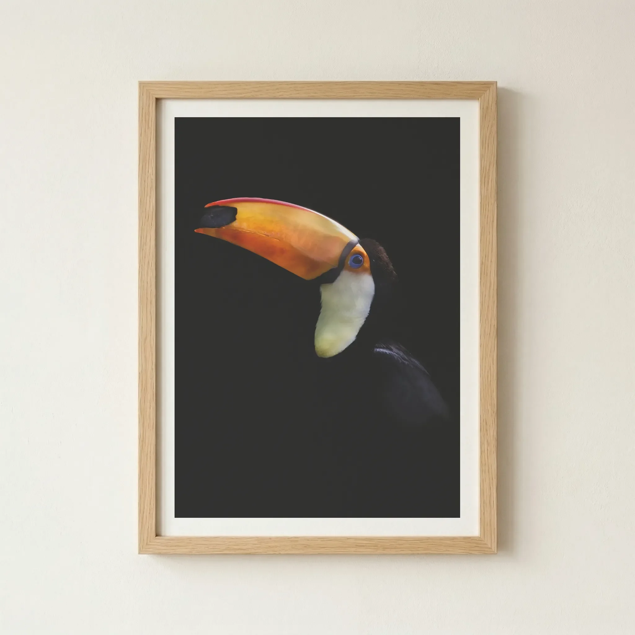 'Toco Toucan' print in a natural wood frame, adding an organic warmth that complements the tropical, jungle-inspired subject.