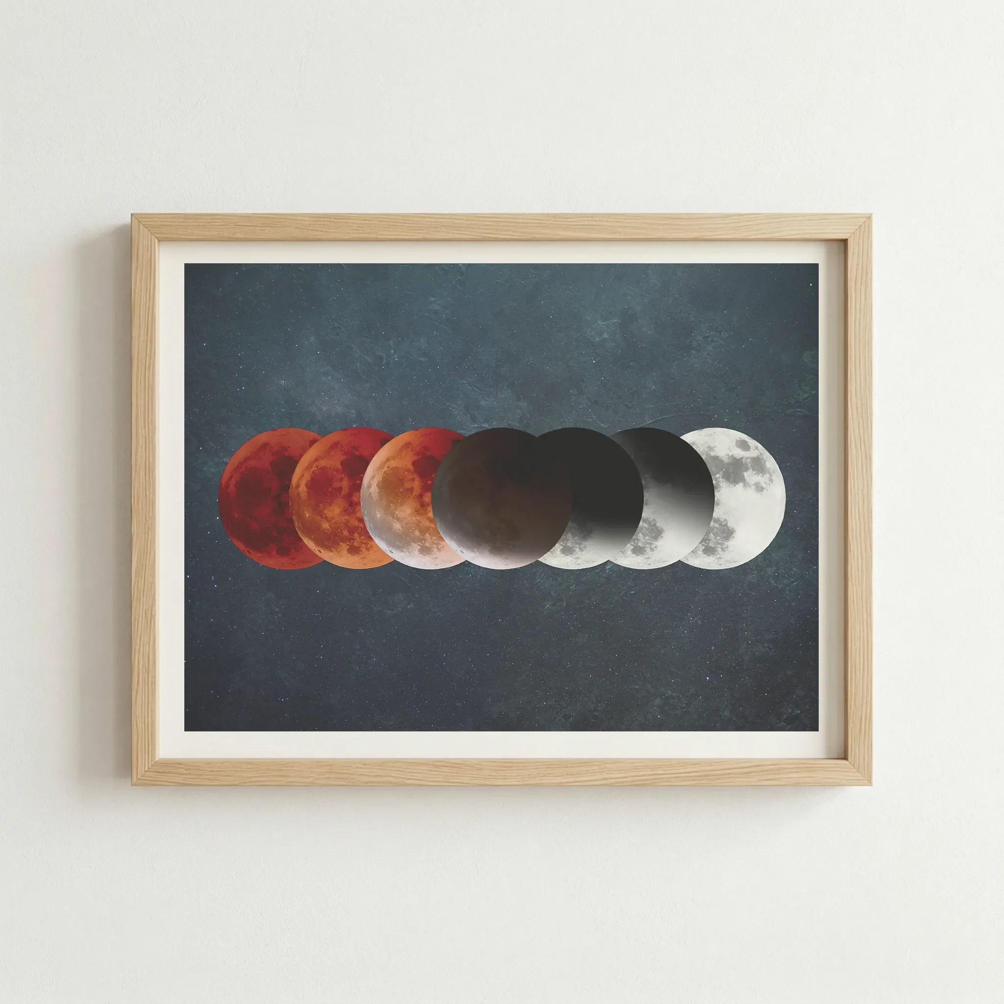 Celestial moon print in a natural wood frame, grounding the cosmic imagery with an organic, earthy finish.