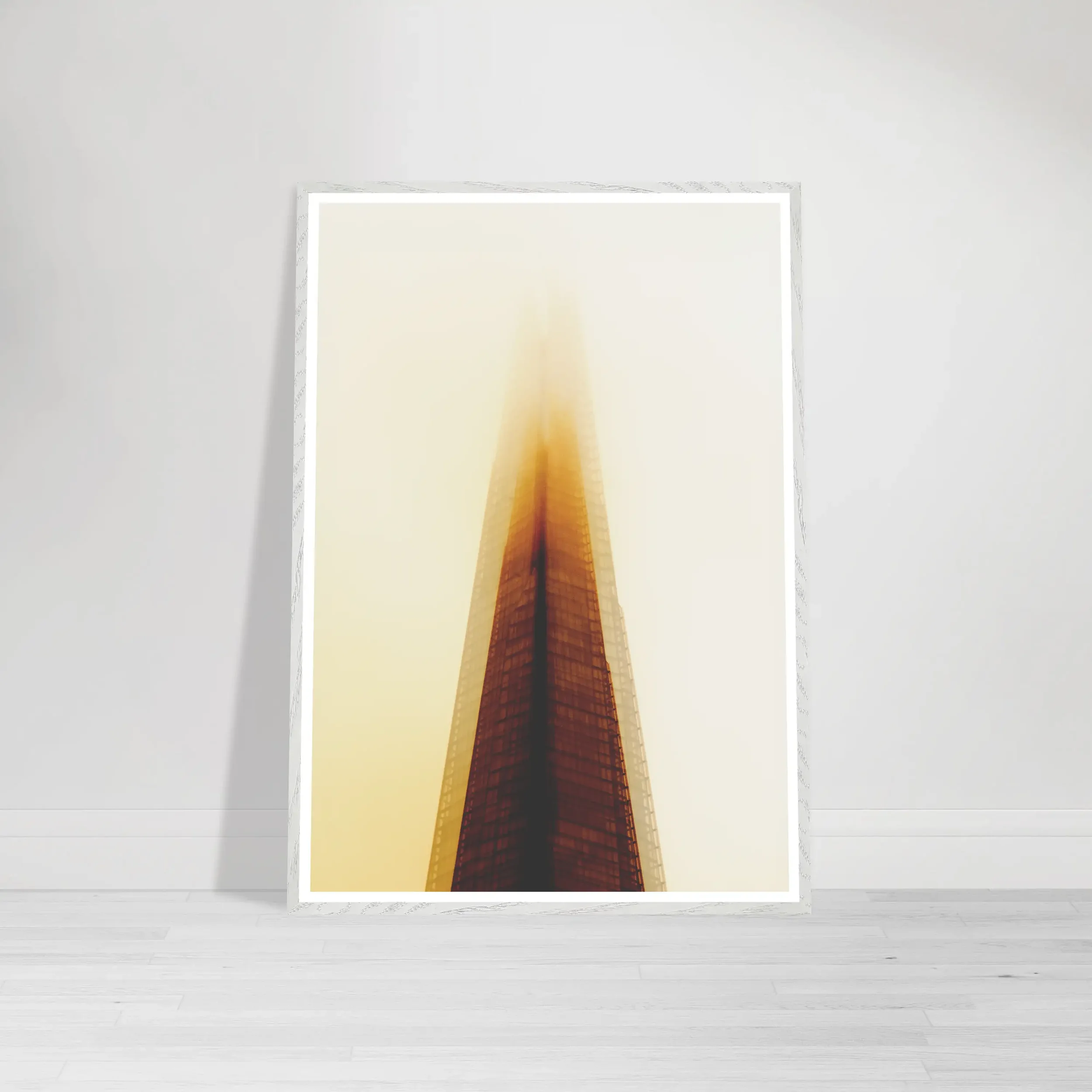 'The Tower of Light' fine art print in a white frame, creating a clean, airy aesthetic that emphasises the ethereal quality of the golden mist.