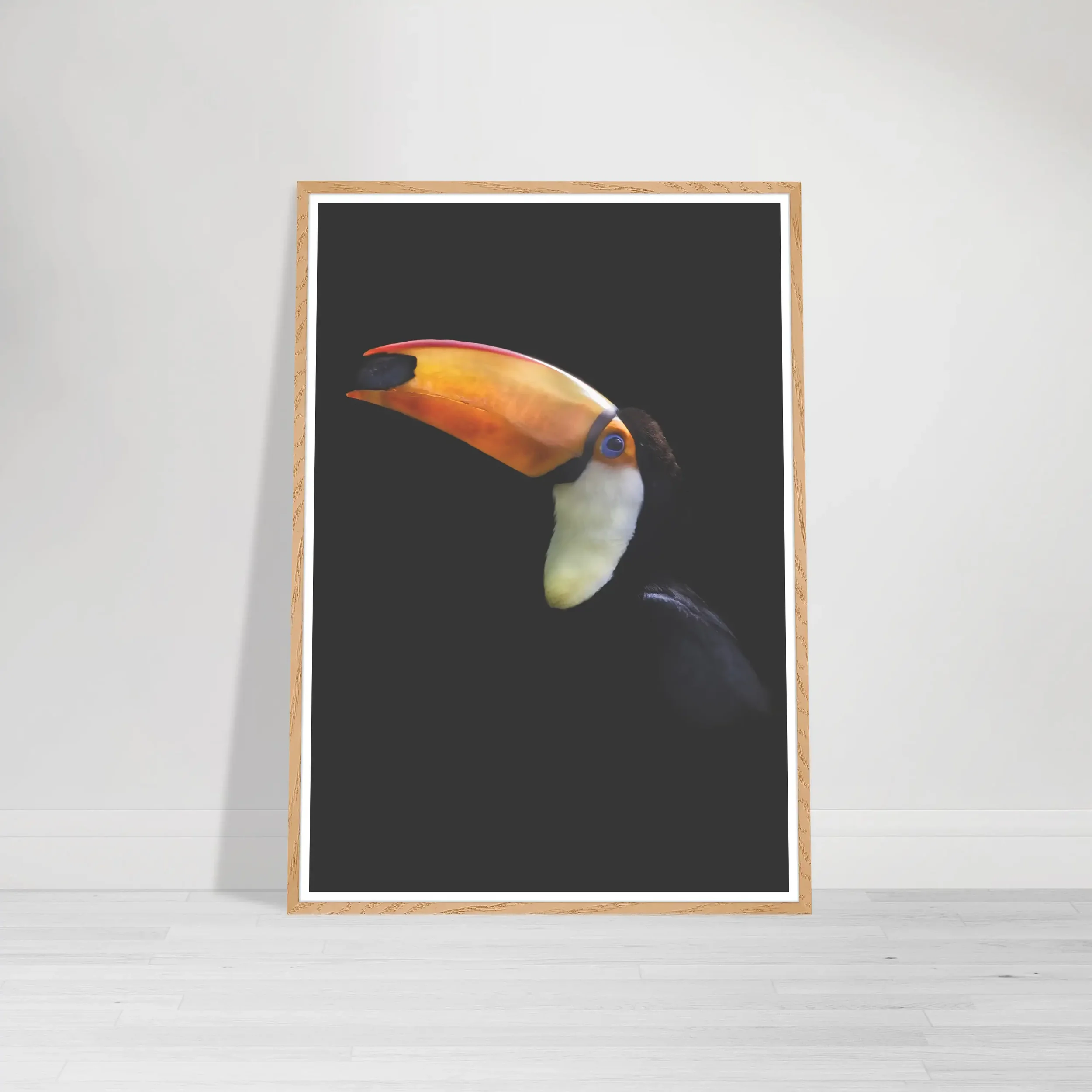 'Toco Toucan' print in a natural wood frame, adding an organic warmth that complements the tropical, jungle-inspired subject.