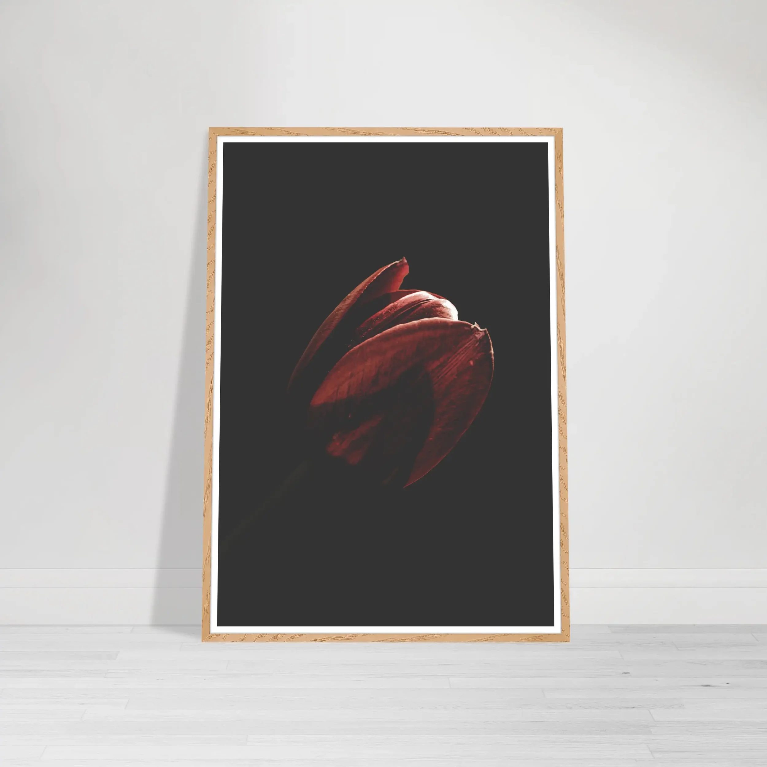 The Tulip print in a natural wood frame, adding a layer of organic warmth to this moody botanical study.