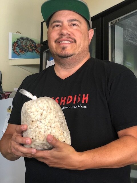 Chef John Whiteduck Ringuette of NishDish in Toronto — holding authentic indigenous white corn.