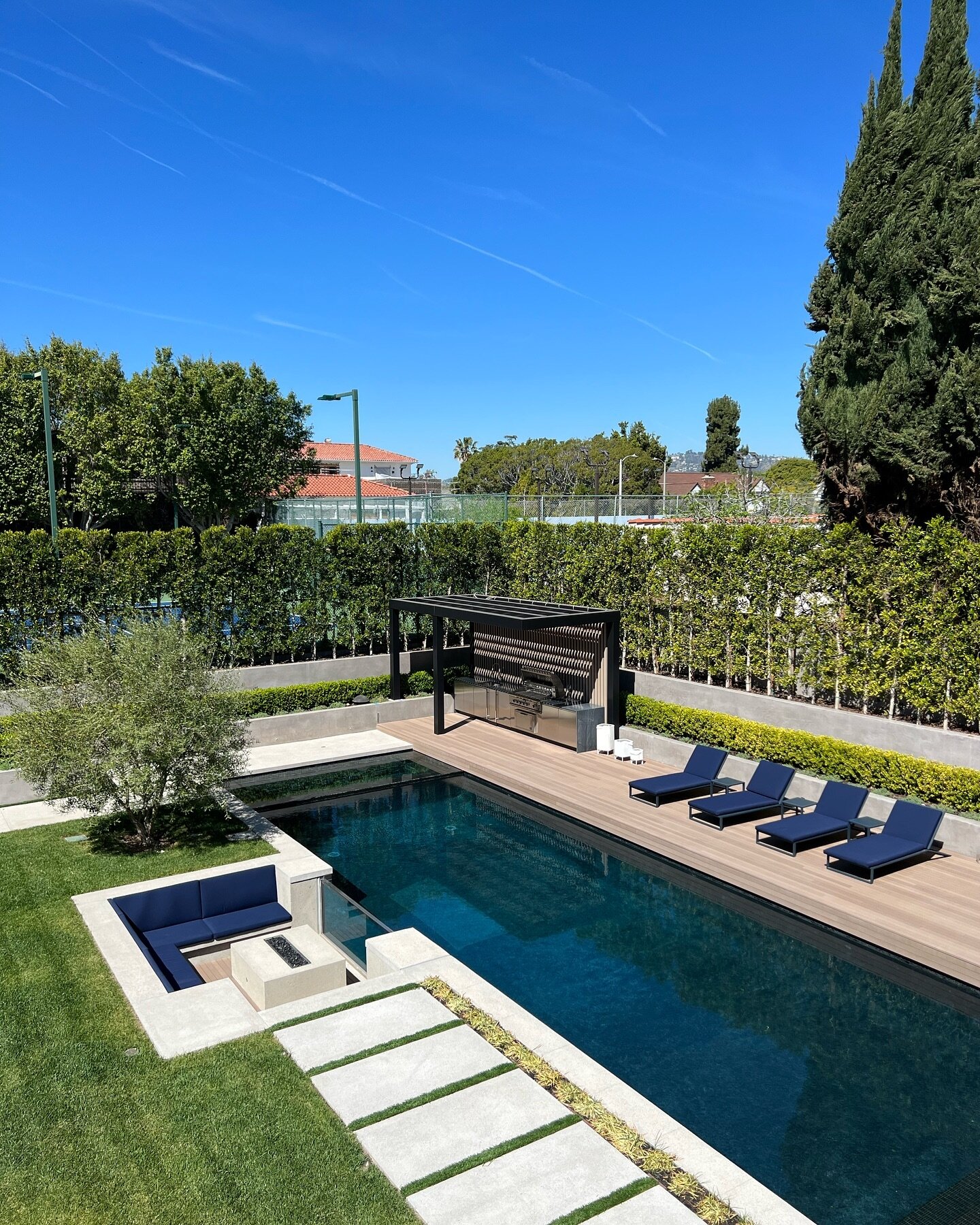 Does this backyard feel like a dream come true? Imagine lounging by the pool with your favorite book, the gentle breeze whispering through the trees, or hosting a vibrant evening of entertainment under the stars, where laughter echoes and memories ar