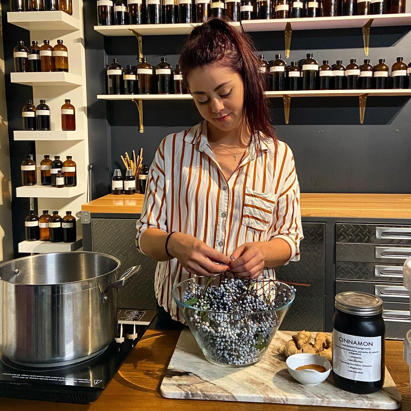 Here I am doing a little garbling of some fresh elderberries for syrup in my herbal garage lab.. Garbling is a fun word that essentially means to separate the desired bits off of the undesired bits when processing herbs. 
.
I am feeling blessed to do