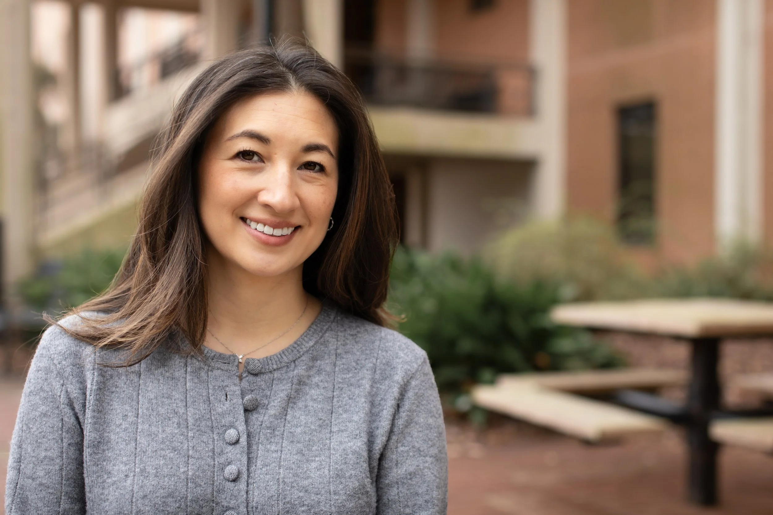 Rebecca Geller is wearing a grey sweater