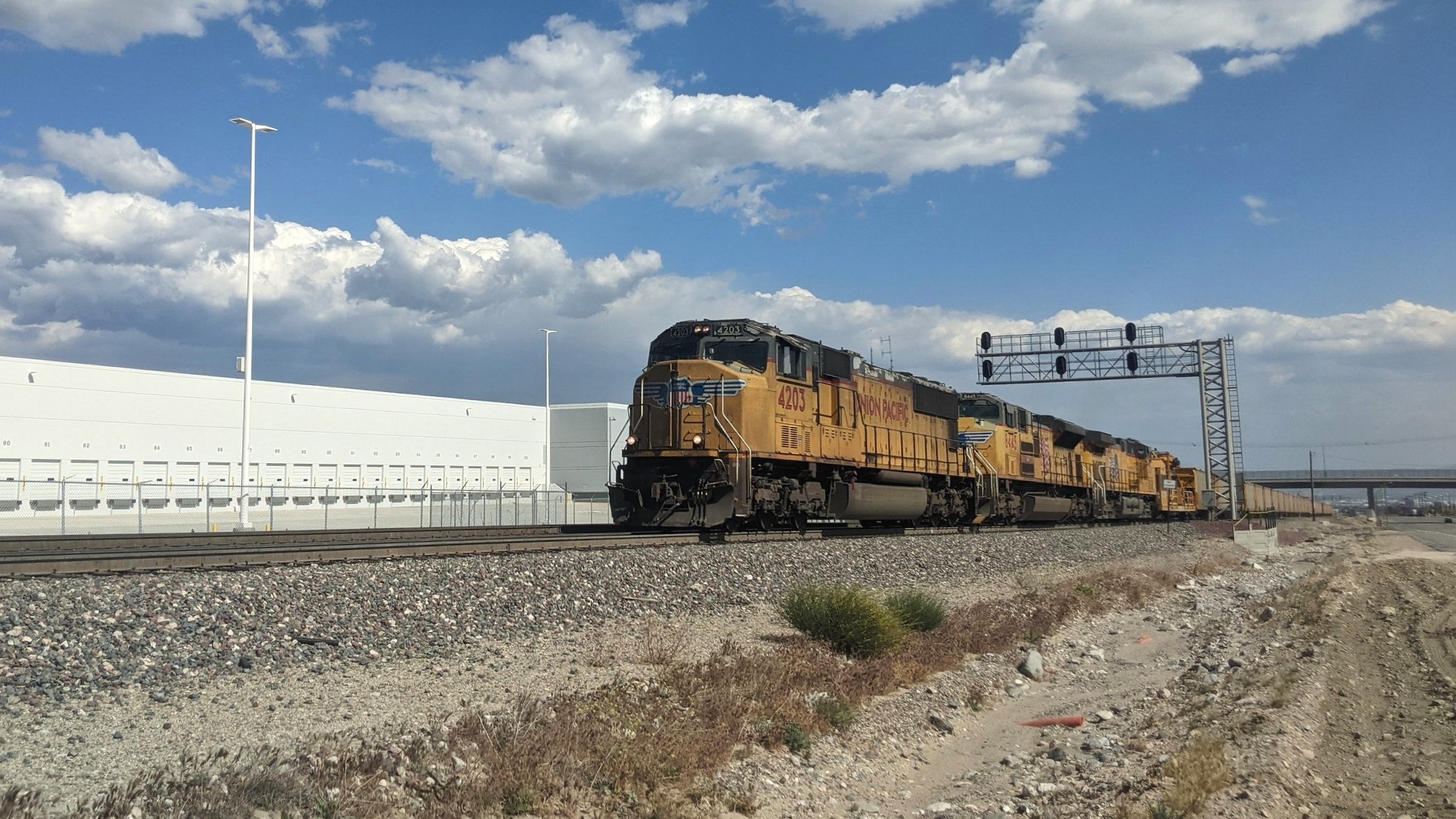  Hauled by a brace of Union Pacific locomotives, Herzog’s ballast maintenance train charges up the approach to Cajon Pass in Verdemont, CA. Photo by Alex Lewis, 2021.  