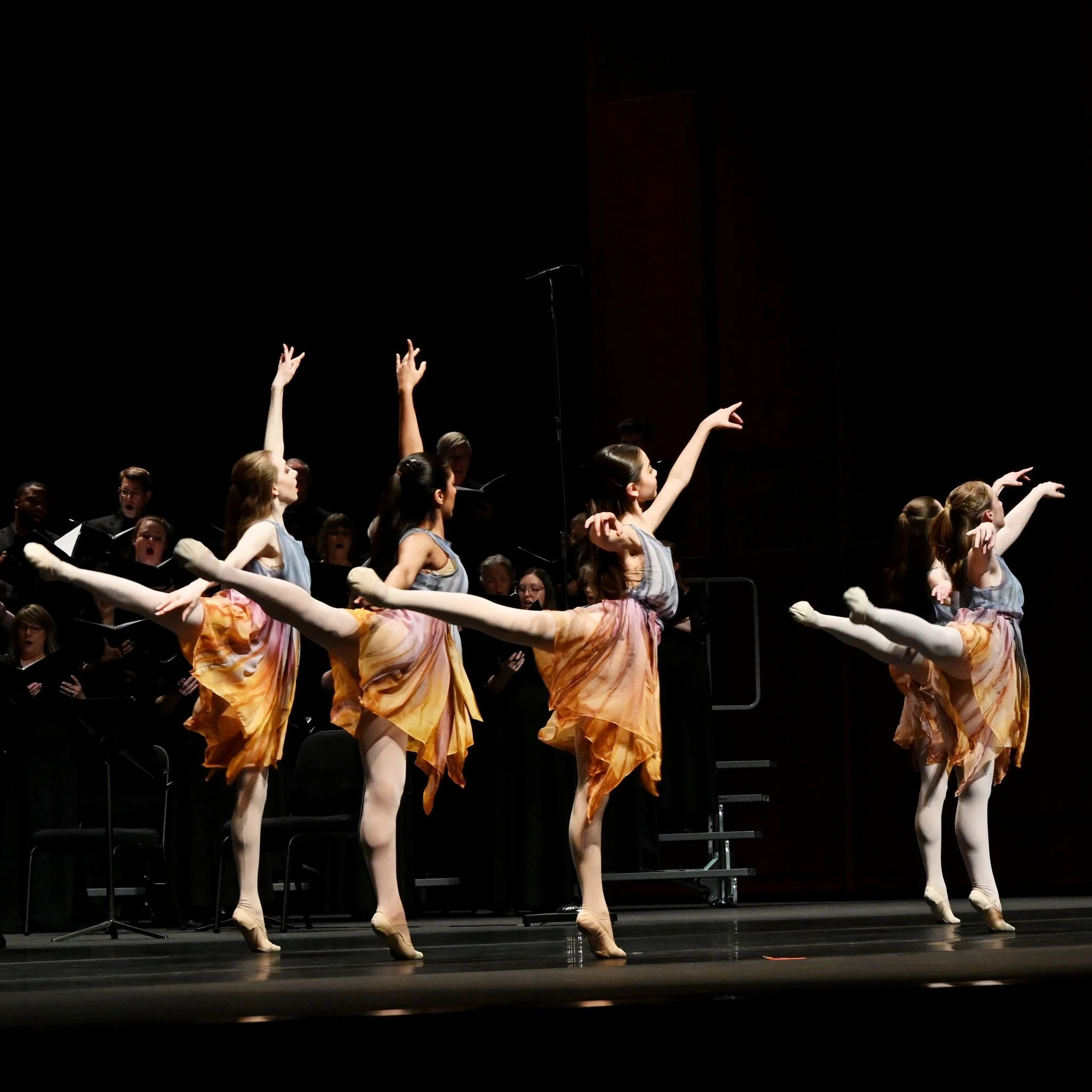 Contemporary dancers in performance on stage.