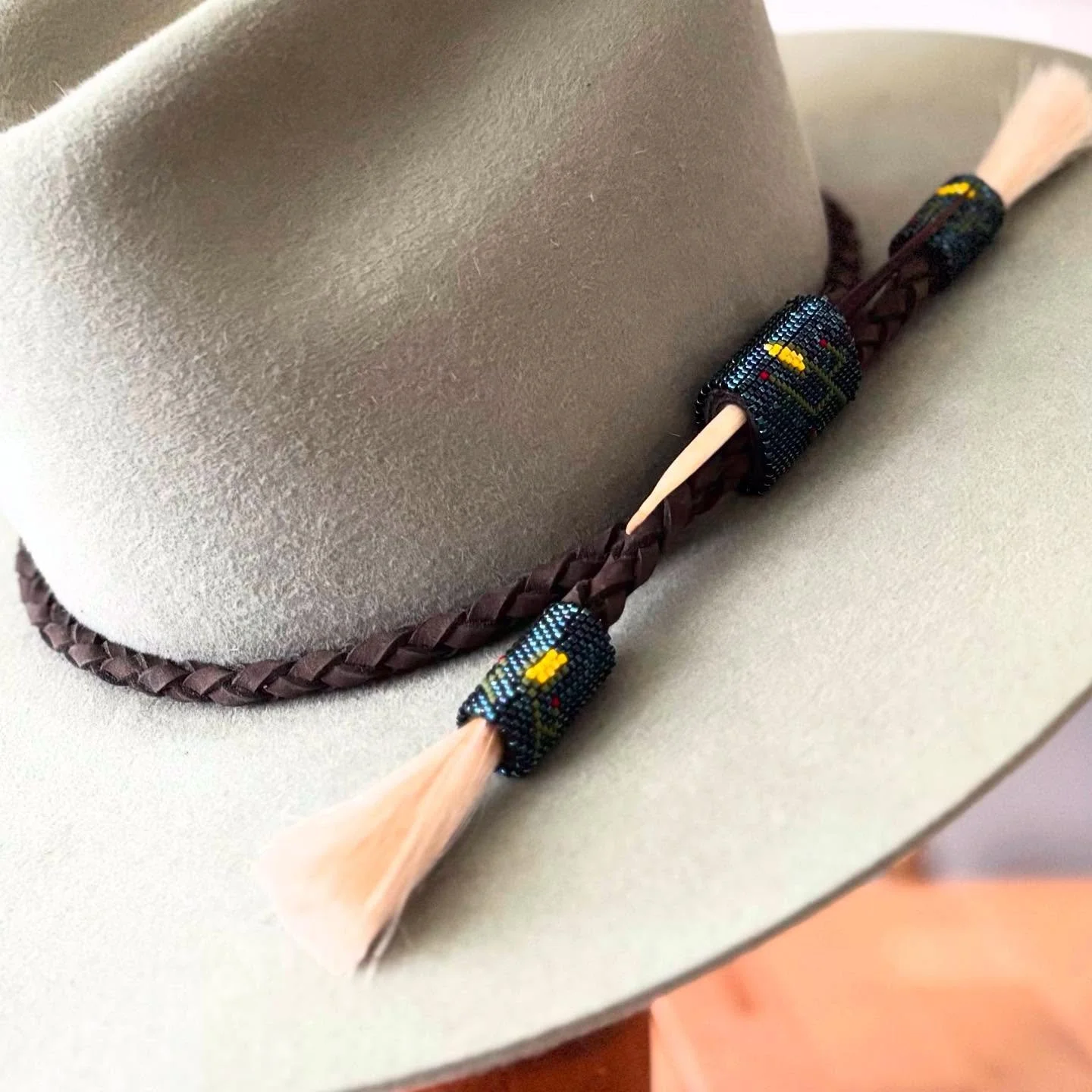 Naadą́ą́ʼ in the universe, peyote stitch beadwork in Lasso hat band. 
Elotl in the universe 
Corn in the universe 
#aghaahatco 
#hatmakersofelpaso 
#hatmakeraofelpasotx 
#smallbusiness
#nativeownedbusiness 
#nativeowned 
#indigenousowned 
#nativeprid