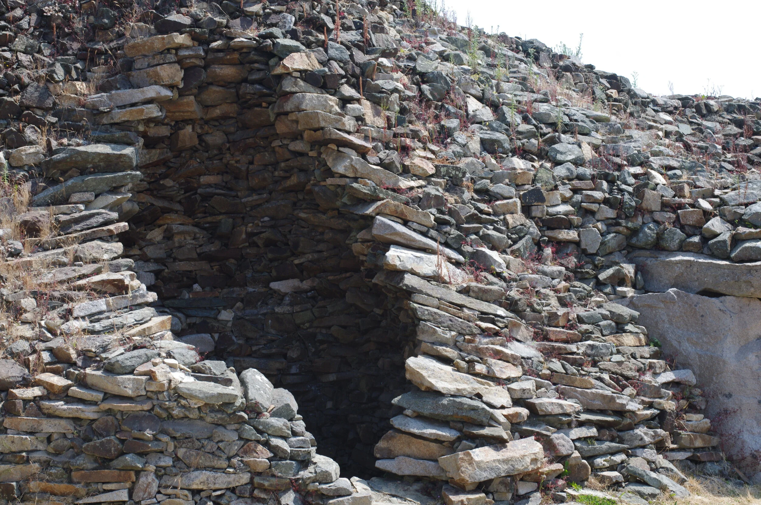  THE SHAPE WAS AN ECHO OF NATURE, WEEDS SURROUNDING  THE CAIRN OF PETIT MONT,  A REMARKABLE, INTACT, ANCIENT NEOLITHIC SITE OVER 6,600 YEARS OLD. TO STAND IT ITS PRESENCE IS HUMBLING AND FORCED ME TO ONCE AGAIN ASK MYSELF WHAT I WAS BUILDING THAT WIL