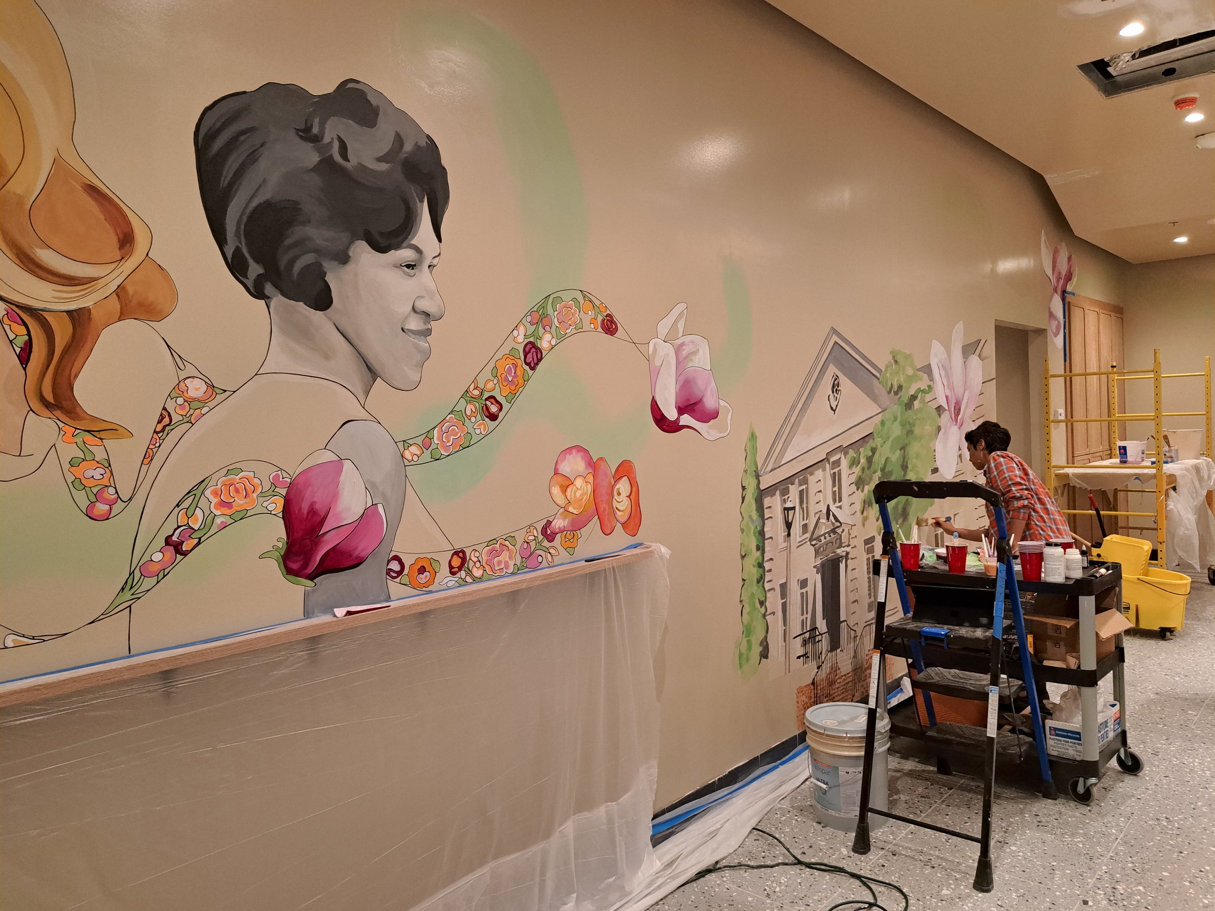 Artist painting Mural of Honrie Monteith Treadwell 