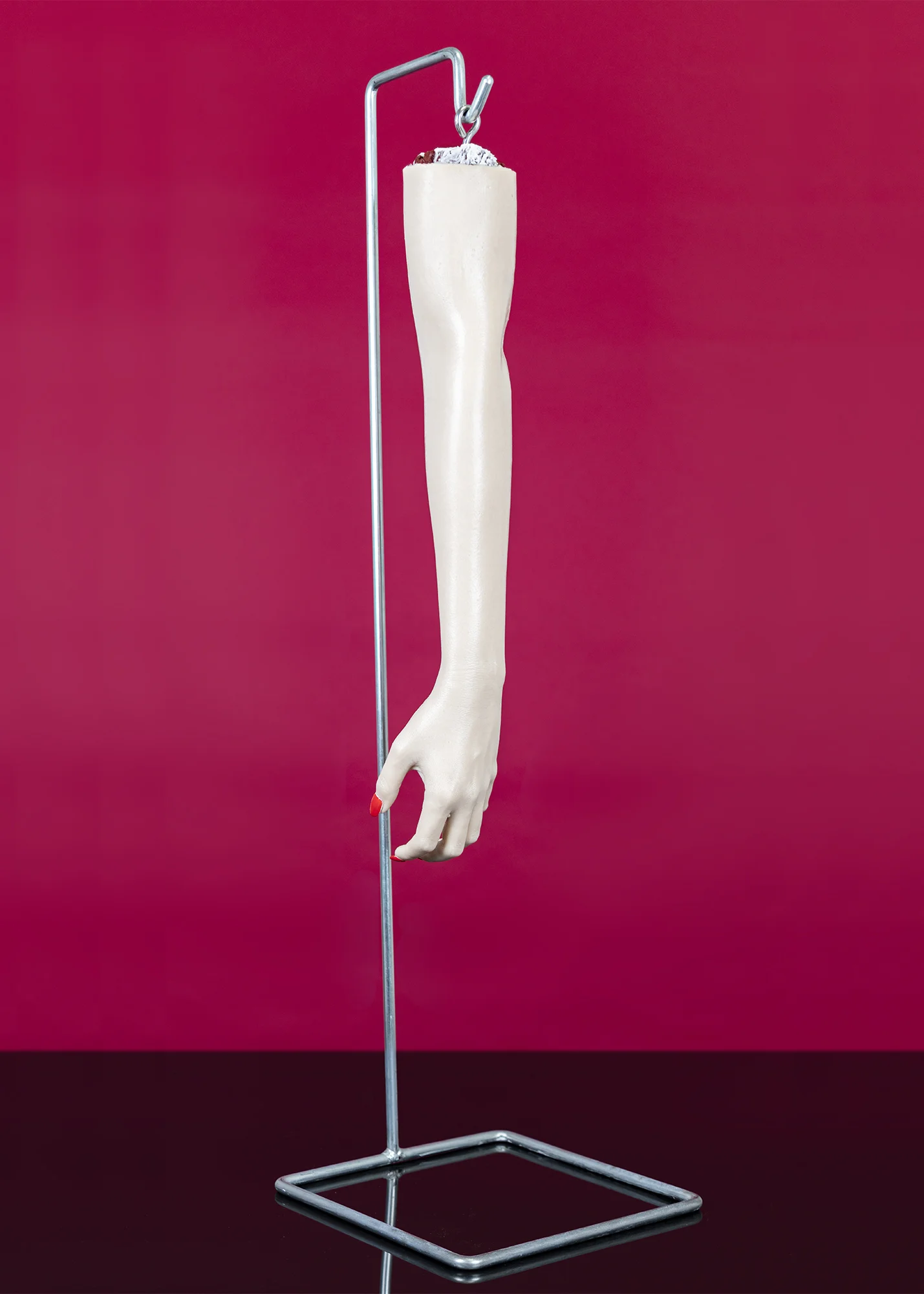Voluntary Amputation , 2018 Silicone rubber, silc pig, wooden dowel, found metal stand, eye hook, plastic finger nails, gel nail lacquer