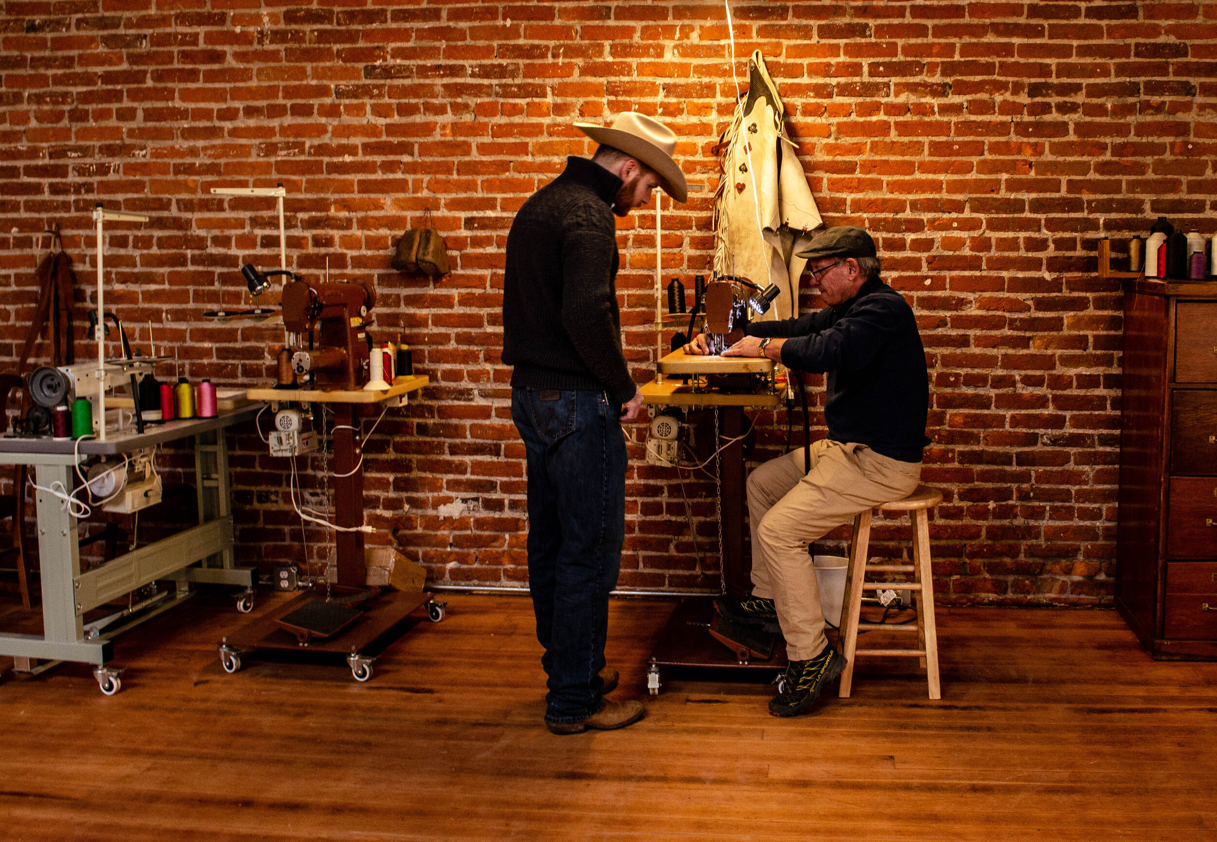Tim observes student sewing leather in Burns, Oregon