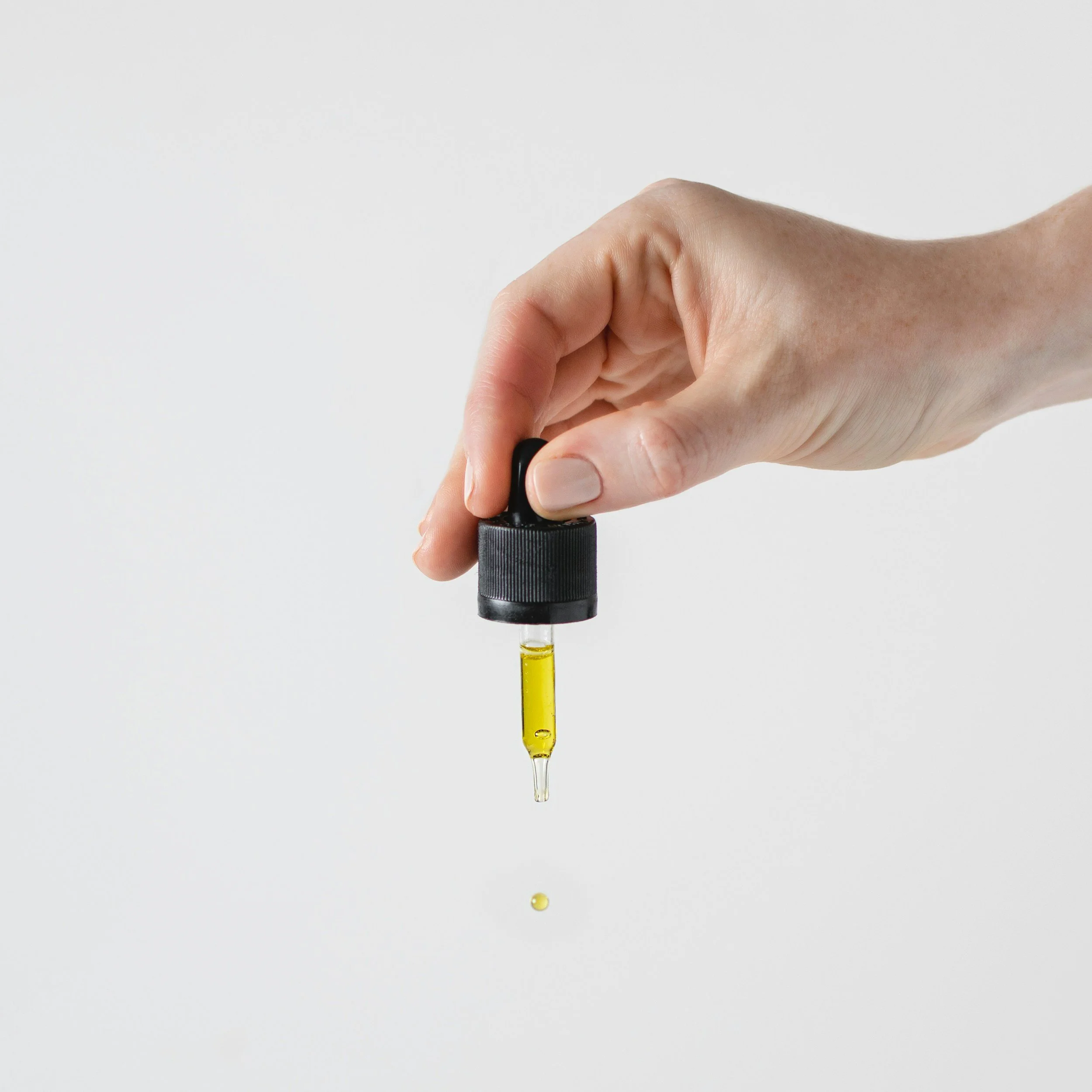 Handmade natural belly oil being poured — Wild Atlantic Wellness Bloom pregnancy belly oil made in small batches in West Cork Ireland using plant-based ingredients