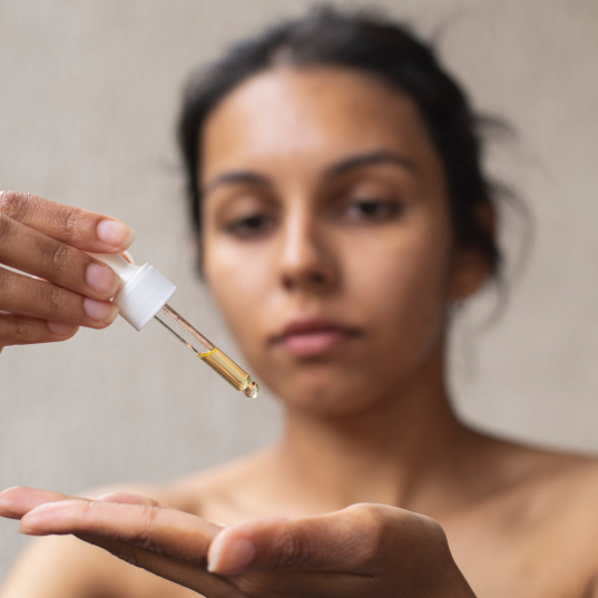 Applying face oil to improve hydration and achieve glowing skin
