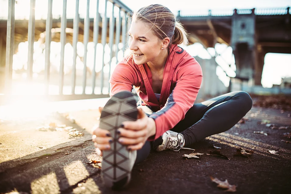 Young woman takes time for herself with exercise as she gets ready for a run.