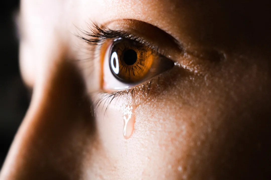 Close up of woman crying in grief over the death of a loved one.