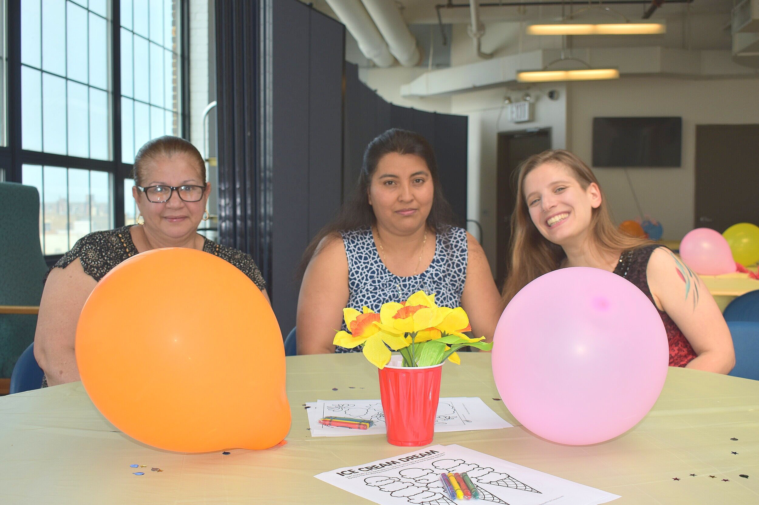 Group of women at table with balloons