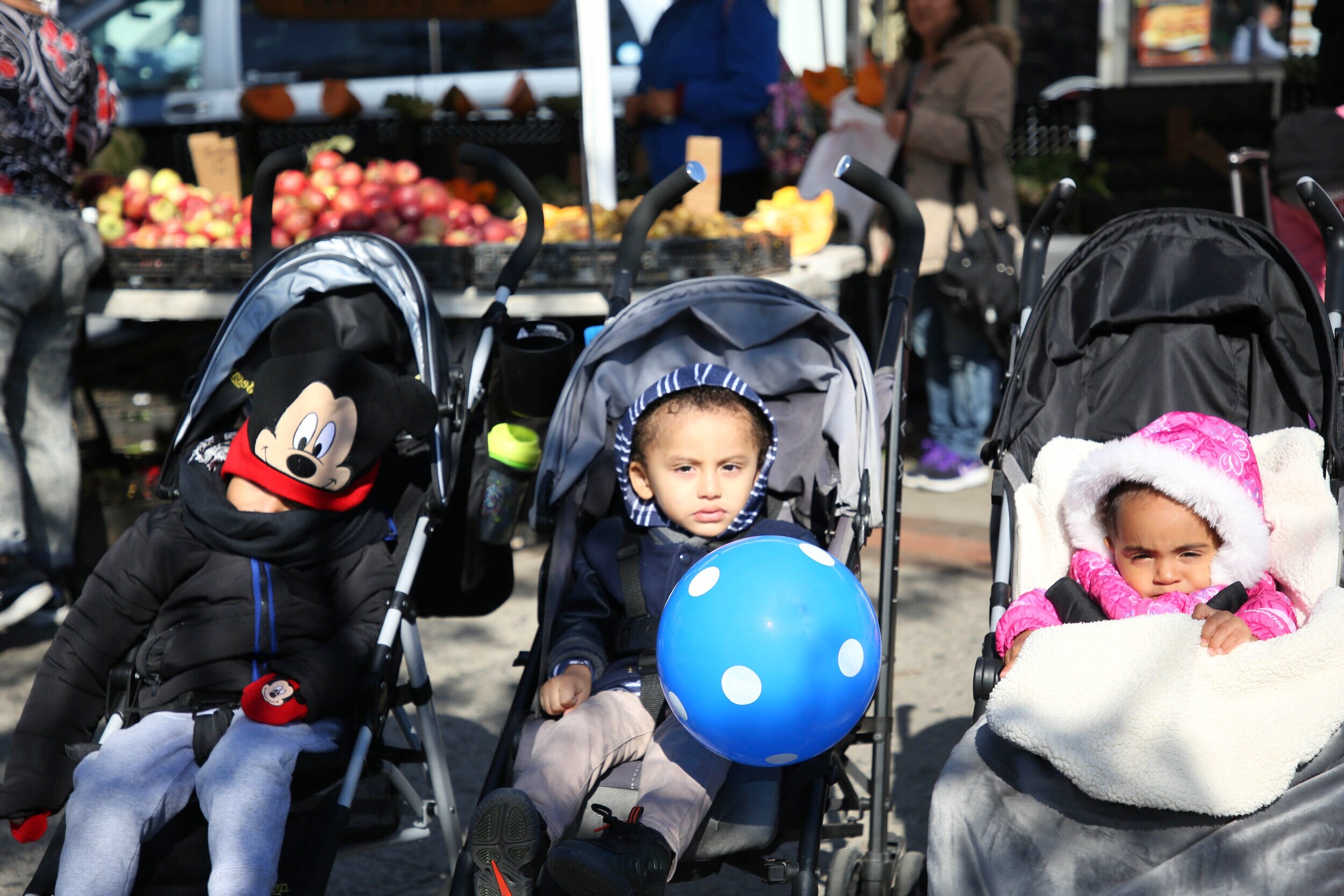 three children in strollers