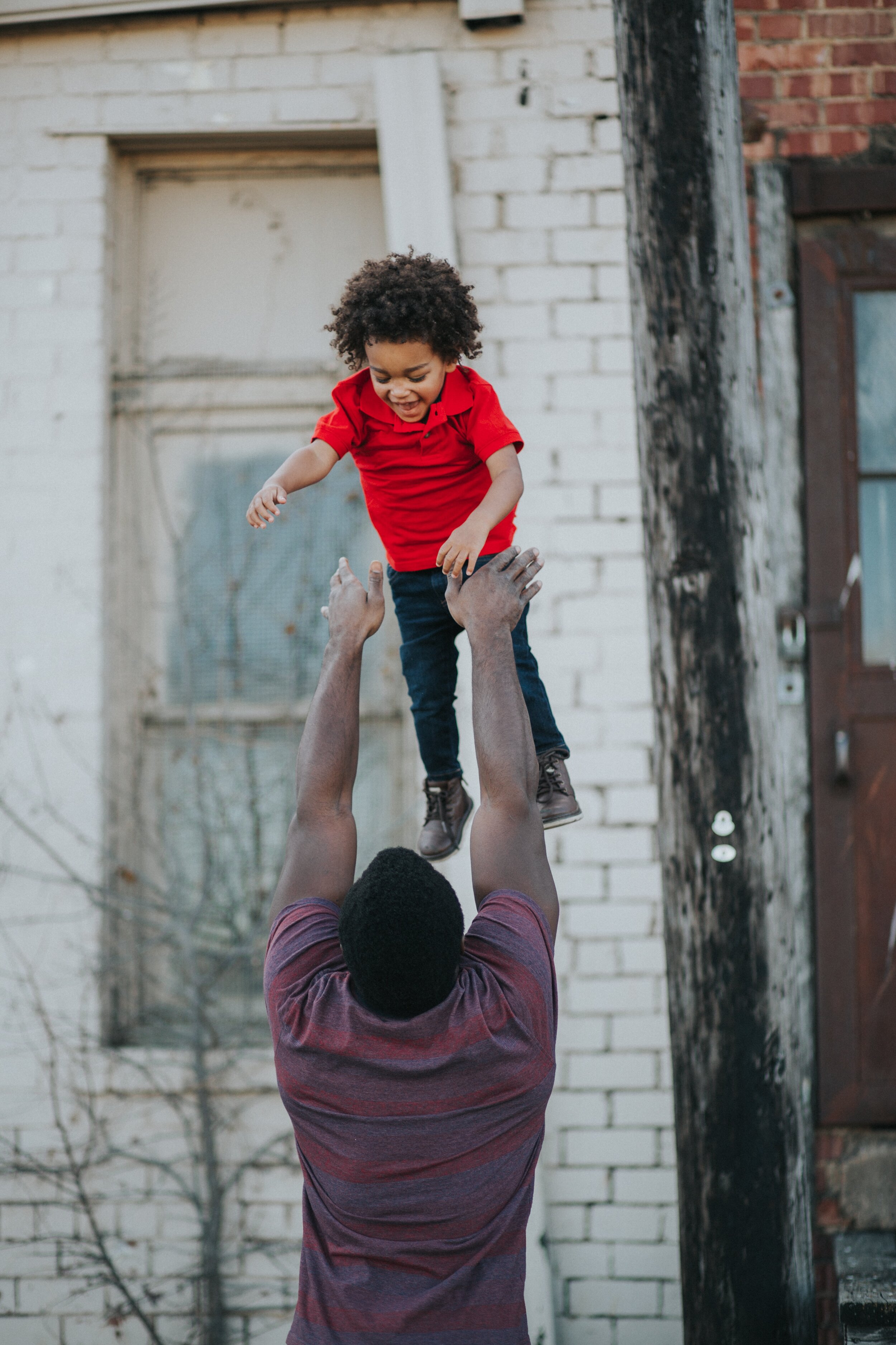 dad playing outside with child