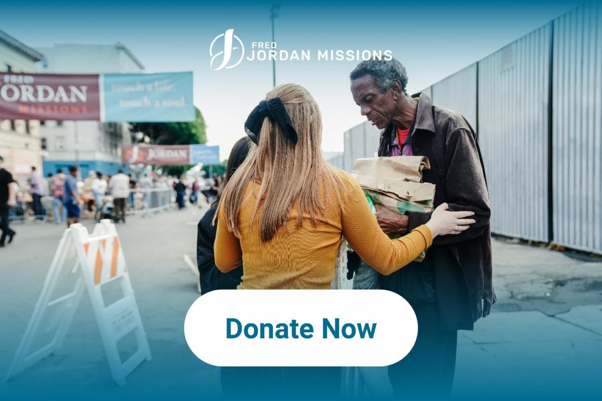 Volunteer handing a food box to a neighbor in need