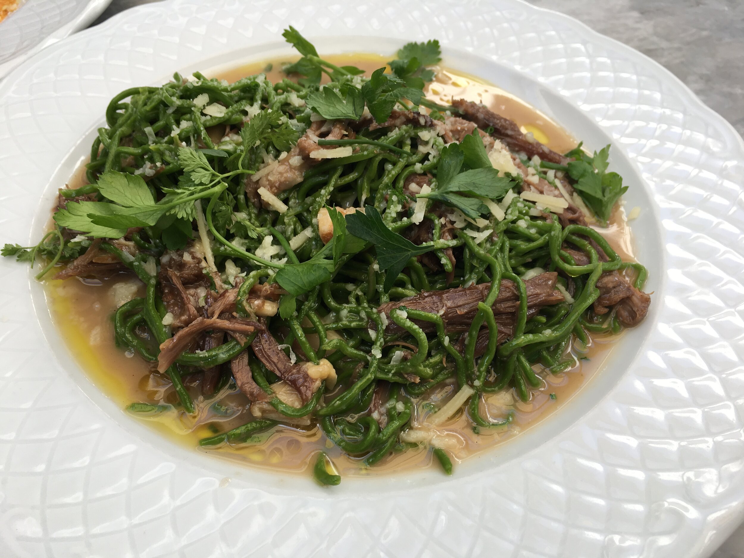  Braised meat dish topped with Triton green algae alternative protein. 