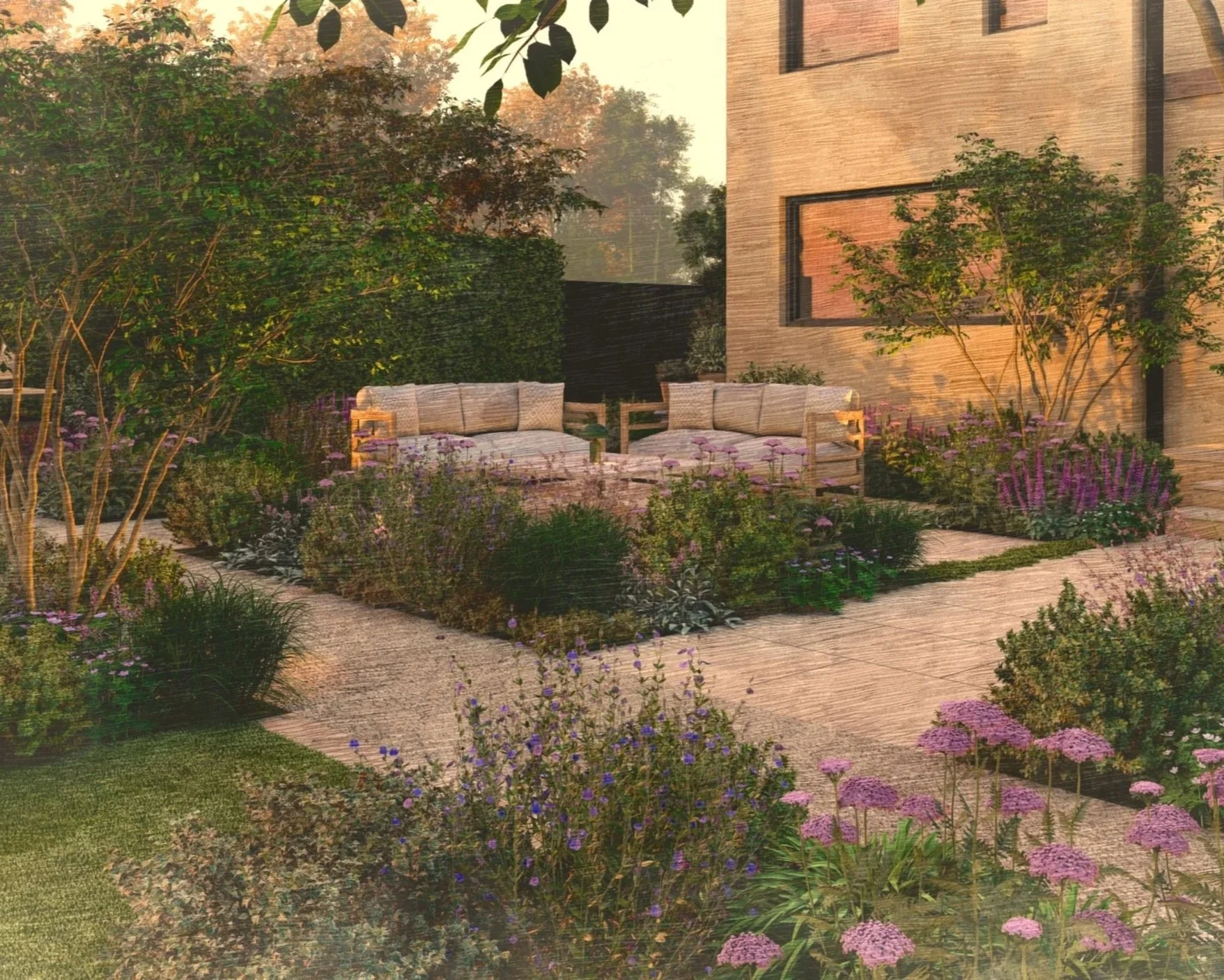 A cozy outdoor patio space with beige wooden furniture including a sofa and a chair, surrounded by lush greenery and colorful flowers, with a modern brick house in the background, during sunset or early evening.