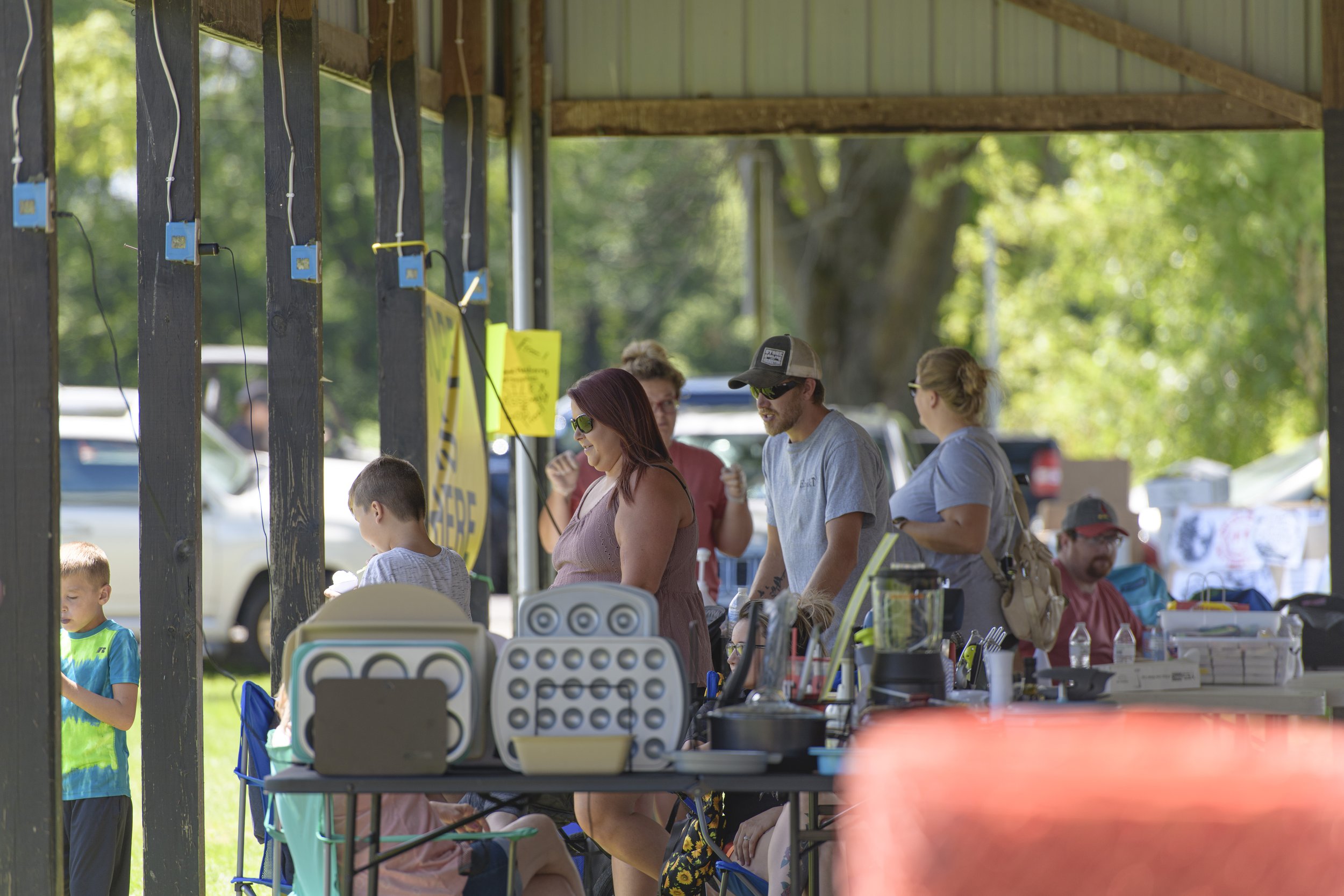 Visitors browse merchandise tables beneath the pavilion at the 2022 Silex Festival.