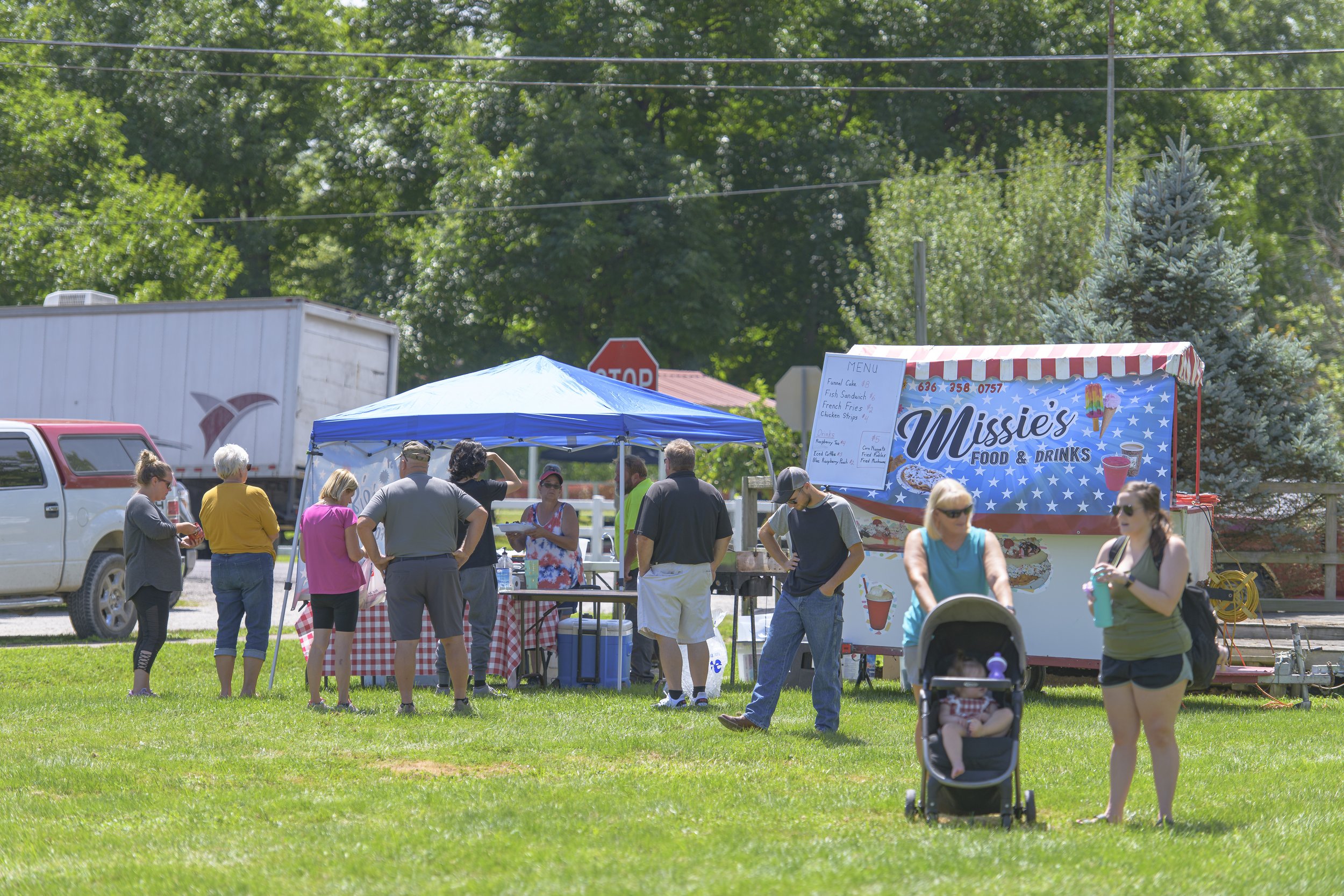Visitors gather beside a food trailer, with a stroller in the foreground at the 2022 Silex Festival.
