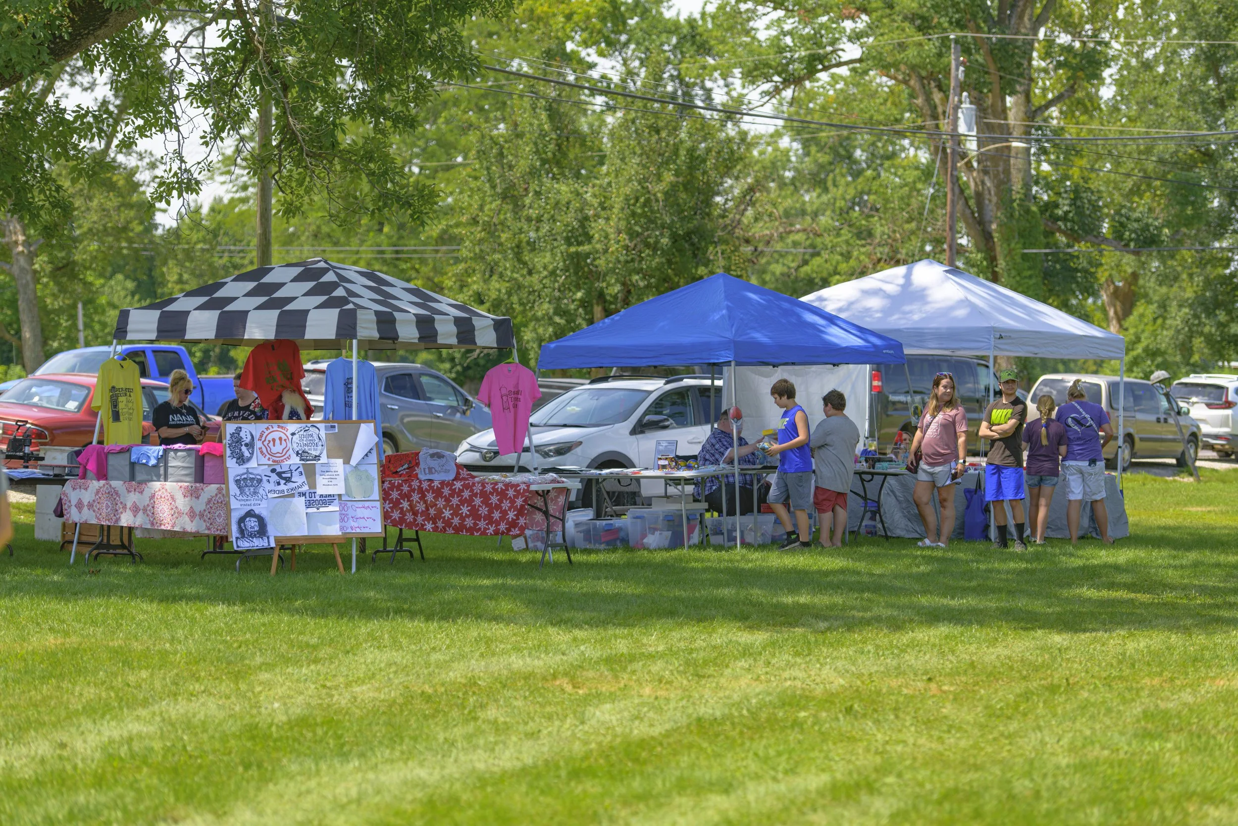 Vendor canopies and colorful textiles line the grassy festival grounds at the 2022 Silex Festival.
